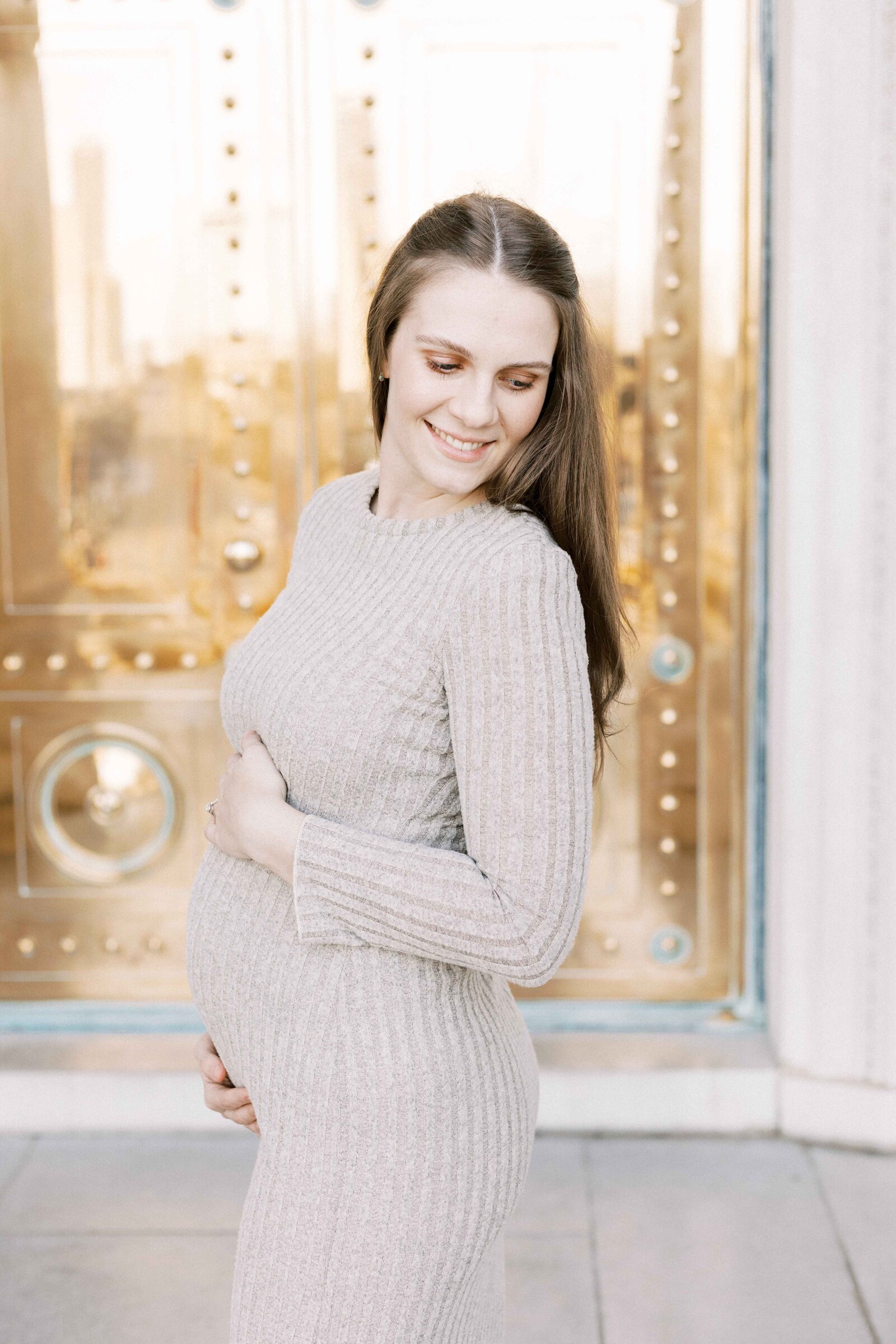mom looking over shoulder smiling in peoria illinois maternity photos 