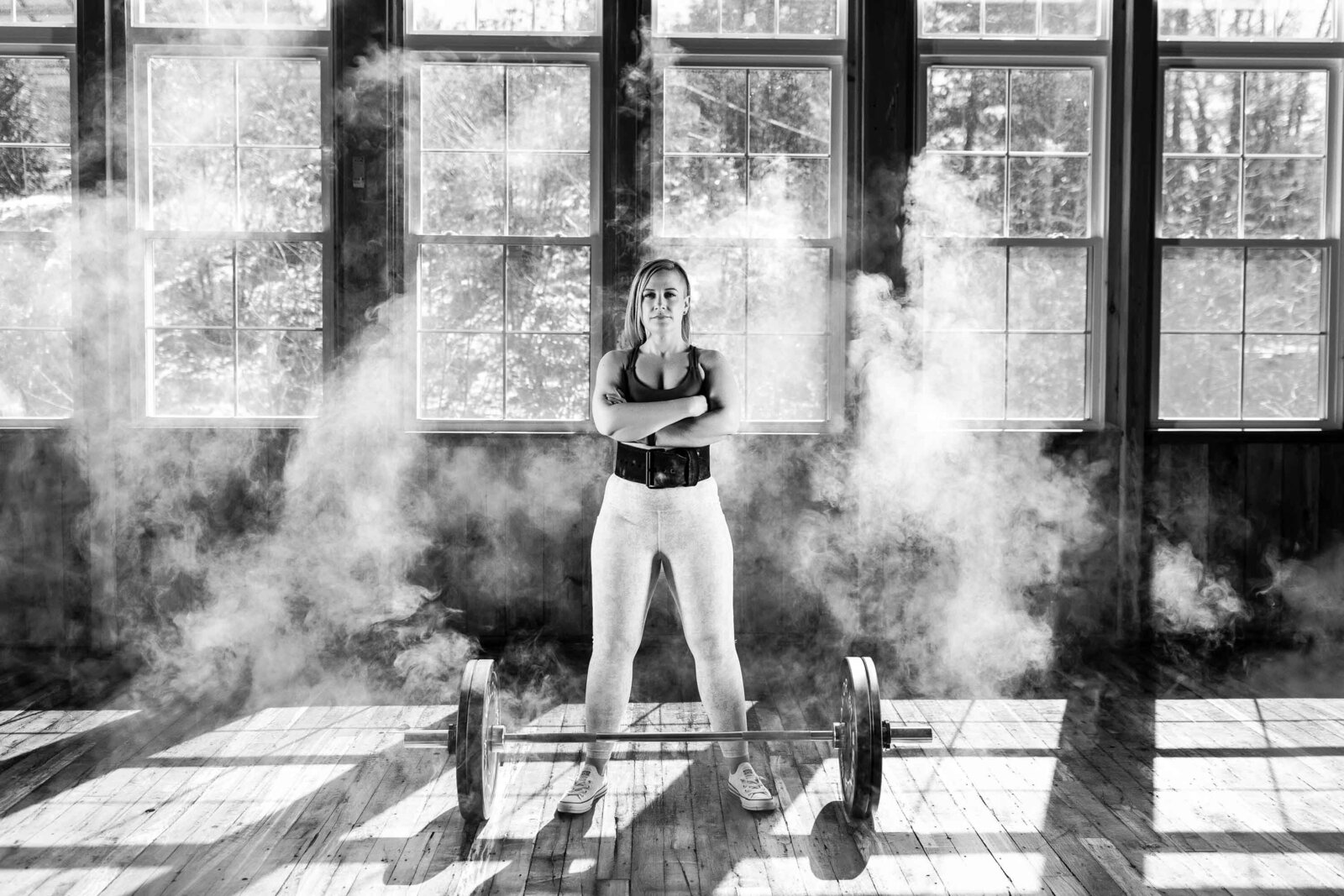 black and white photo of a woman with dumbell