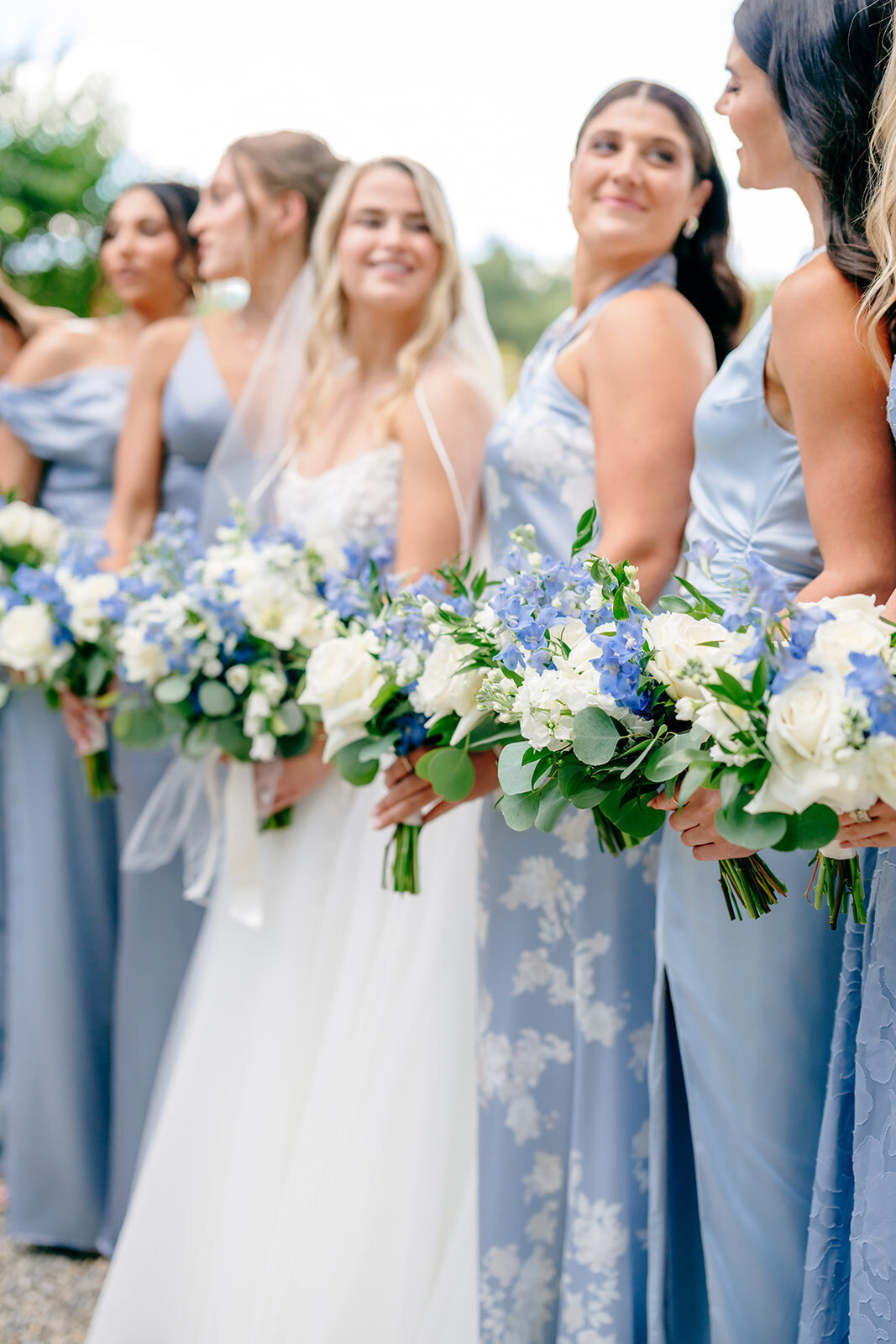 bride with bridesmaids holding bouquets