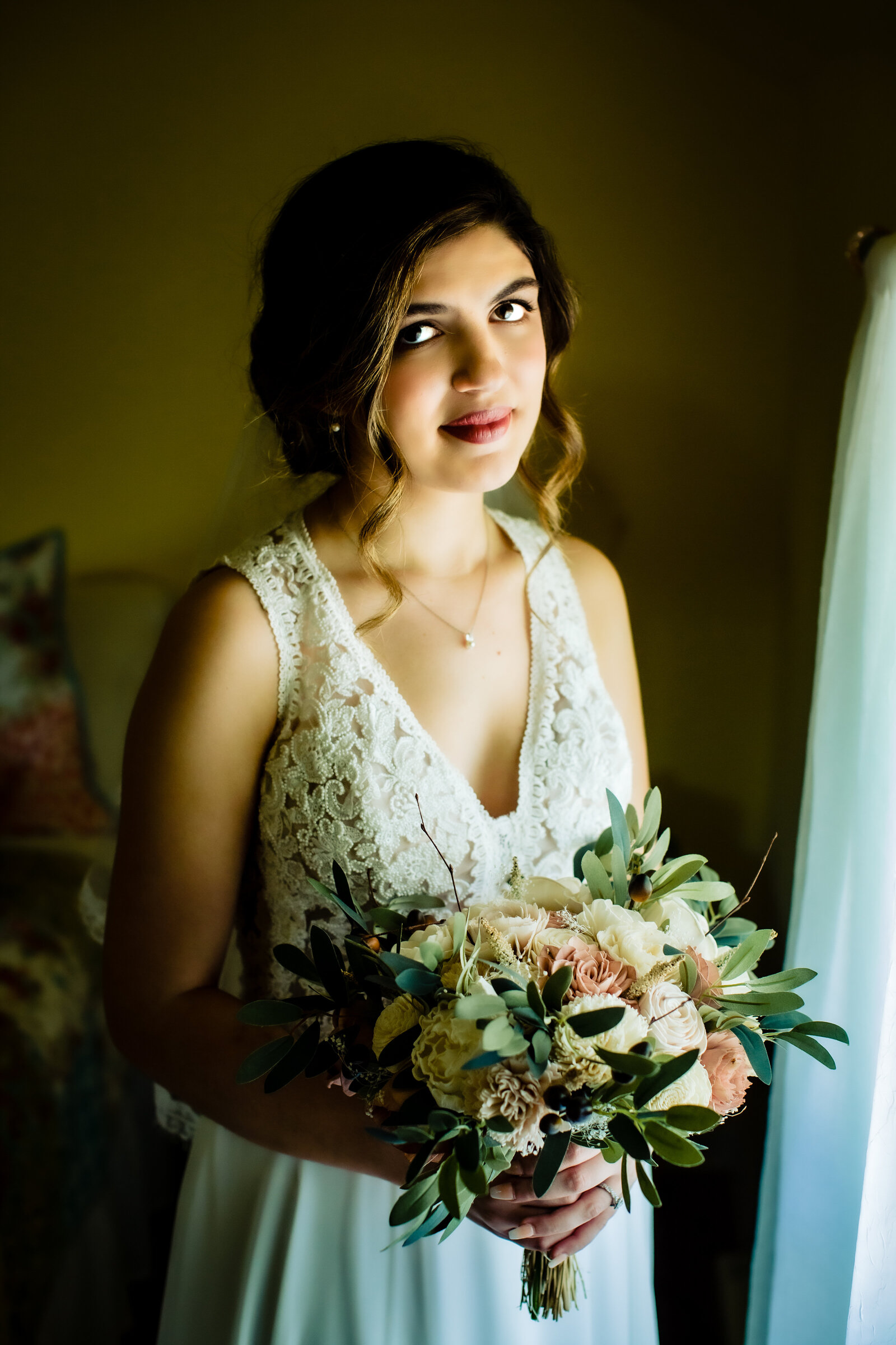 Bride looking at camera with her bouquet