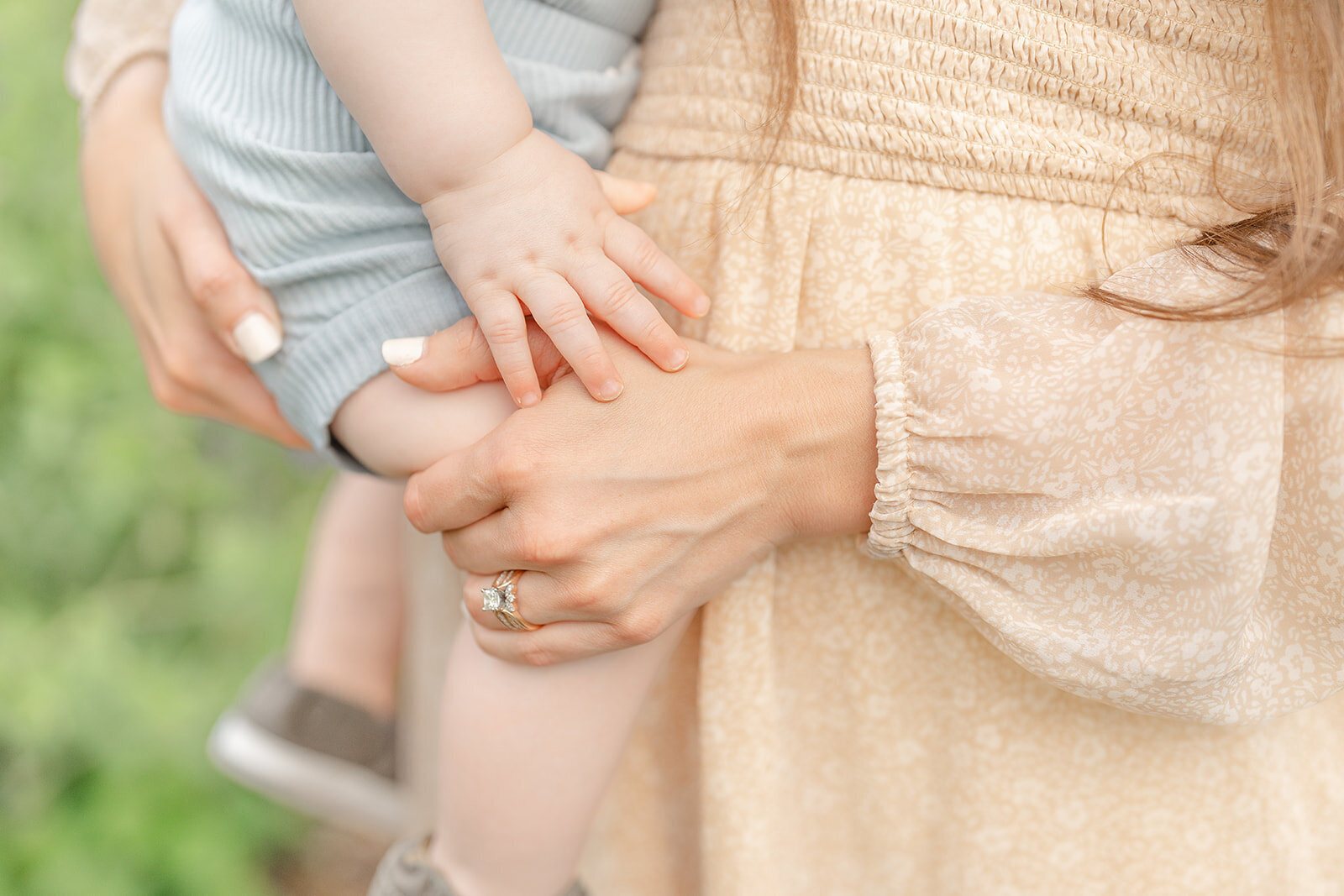 baby holding mom’s hand during Warrenton, Virginia family photo