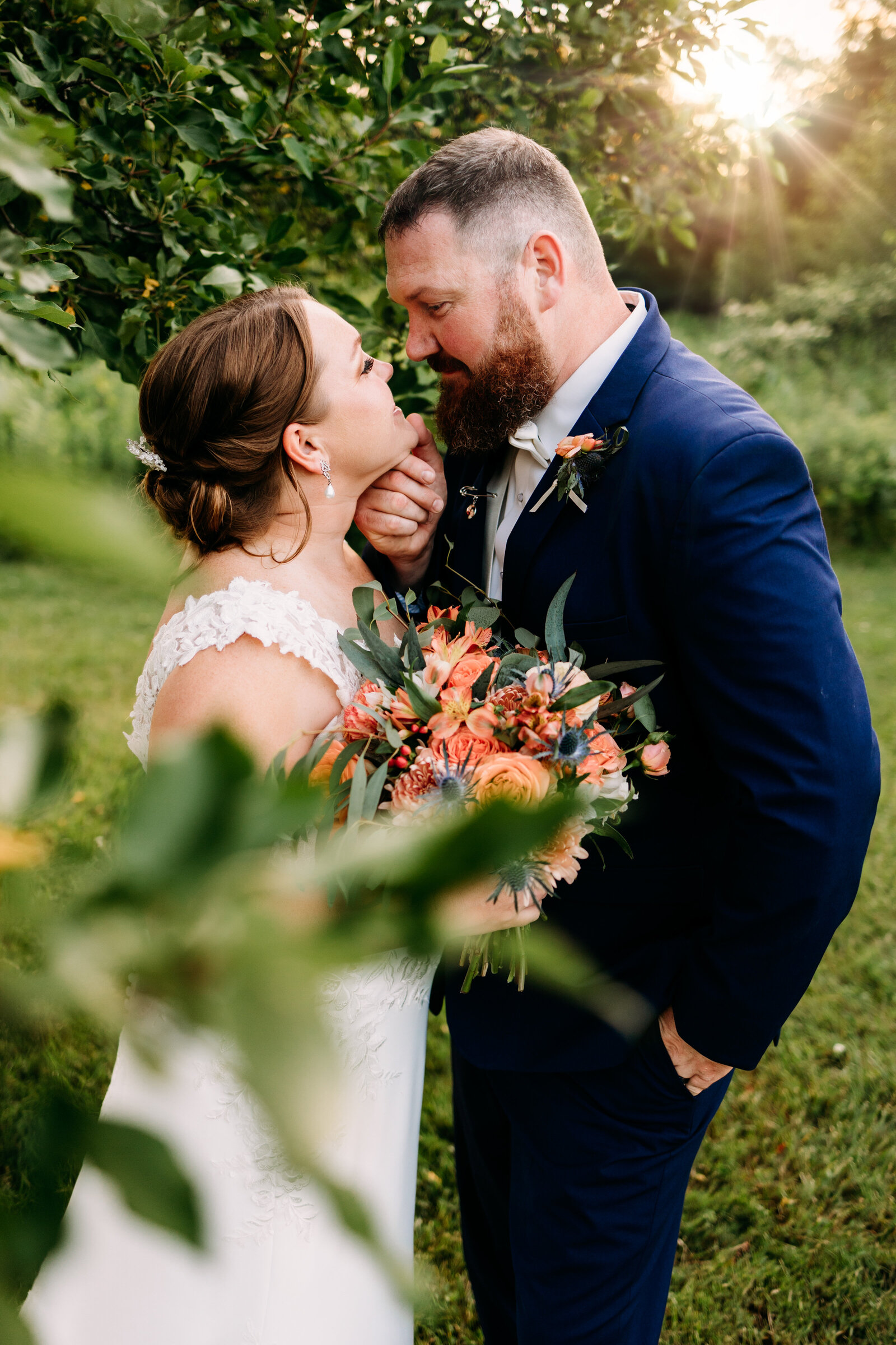 Groom tenderly pulls bride in for a kiss  ON THEIR WEDDING DAY