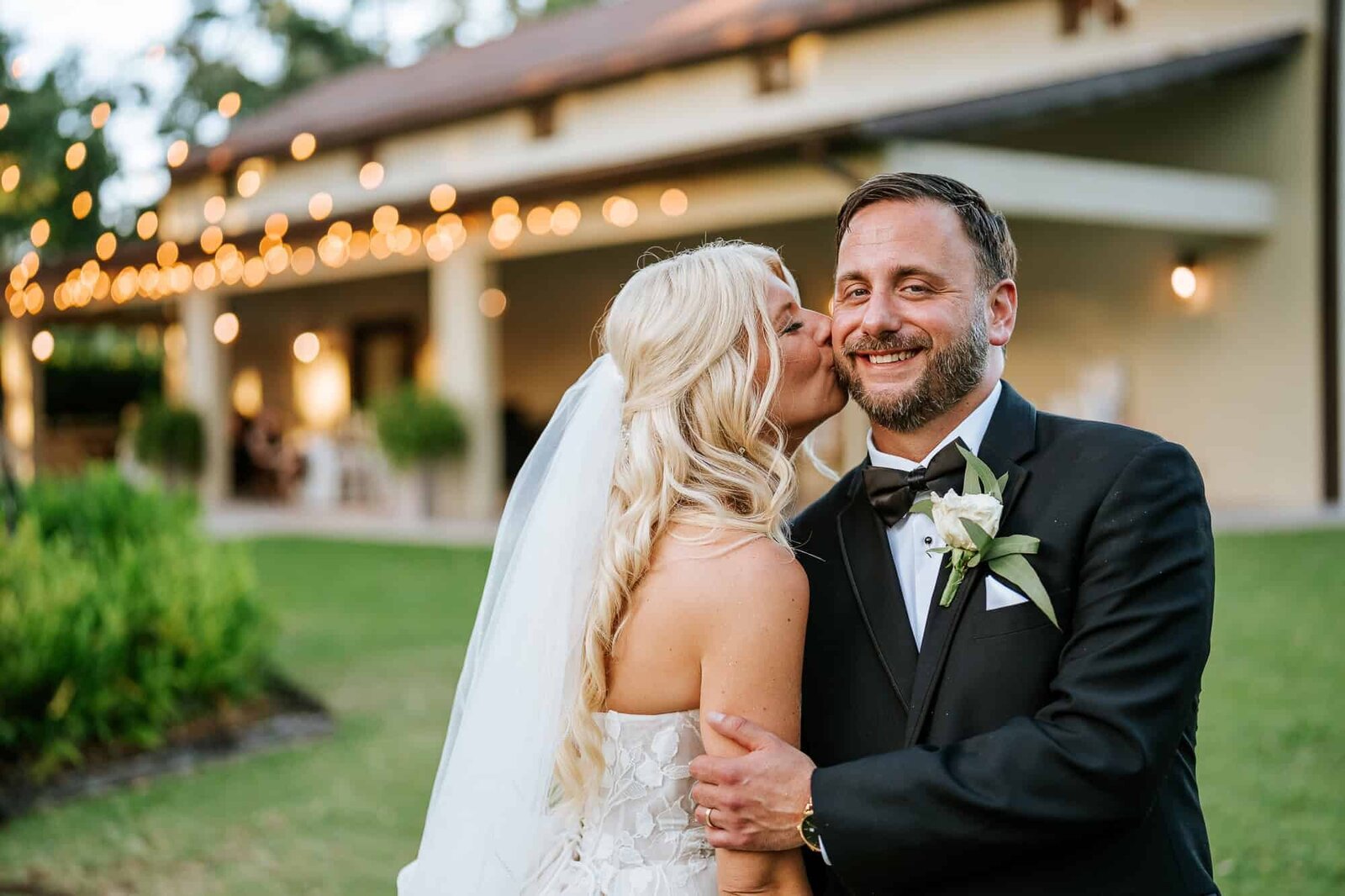 Evening shot of Baker’s Ranch venue lit with market lights and glowing lanterns.