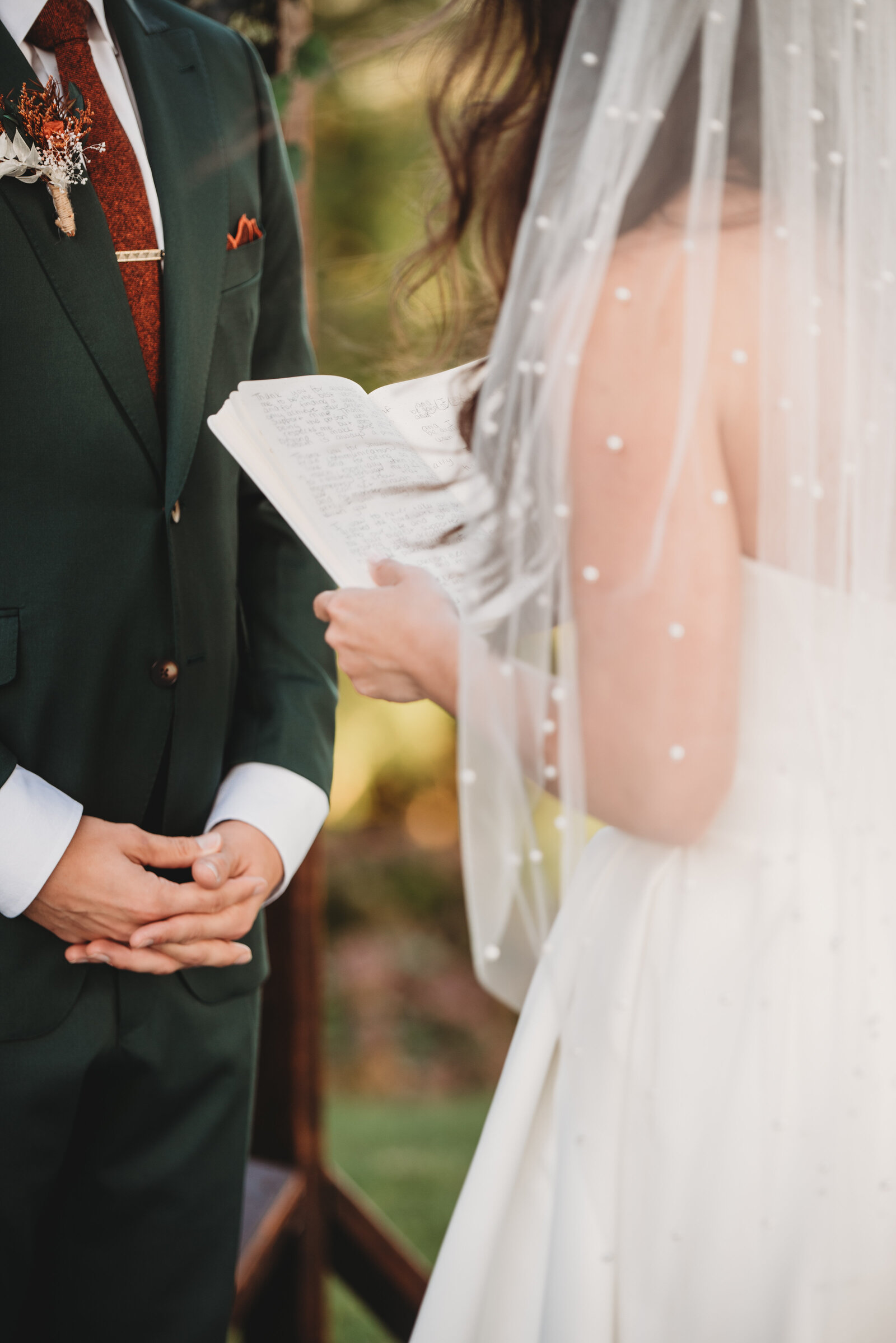 A heartfelt moment as a bride reads her vows to her groom during their outdoor wedding ceremony in Connecticut. This intimate wedding detail captures the essence of love, commitment, and personal promises made on a couple’s special day. Perfect inspiration for modern and romantic wedding ceremonies.