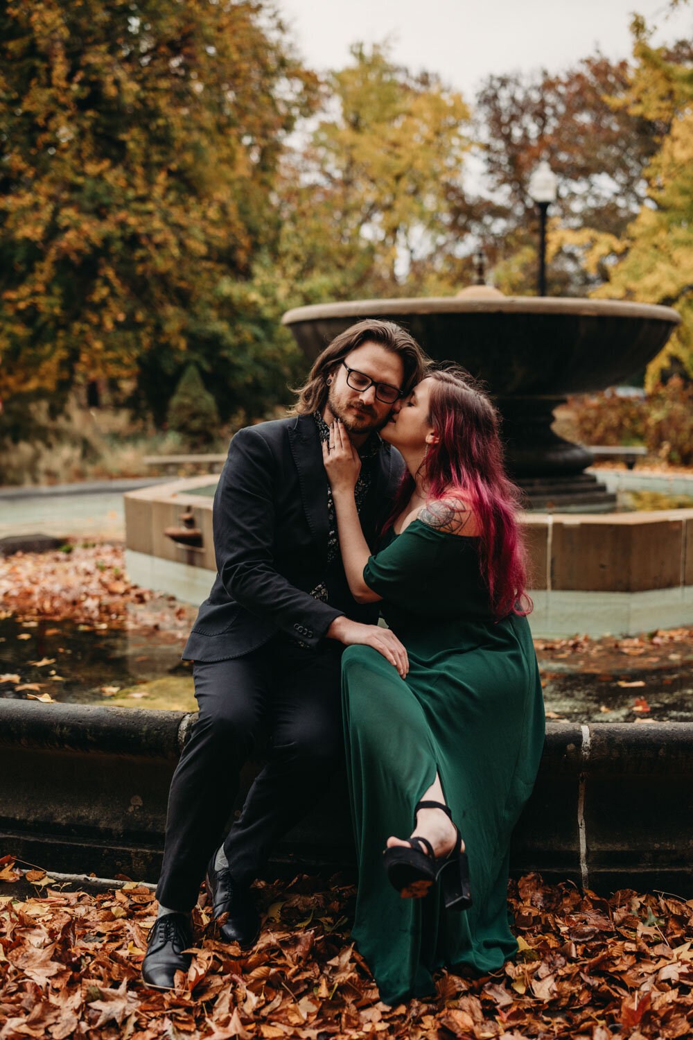 Partner kisses cheek in New York like setting during the Fall