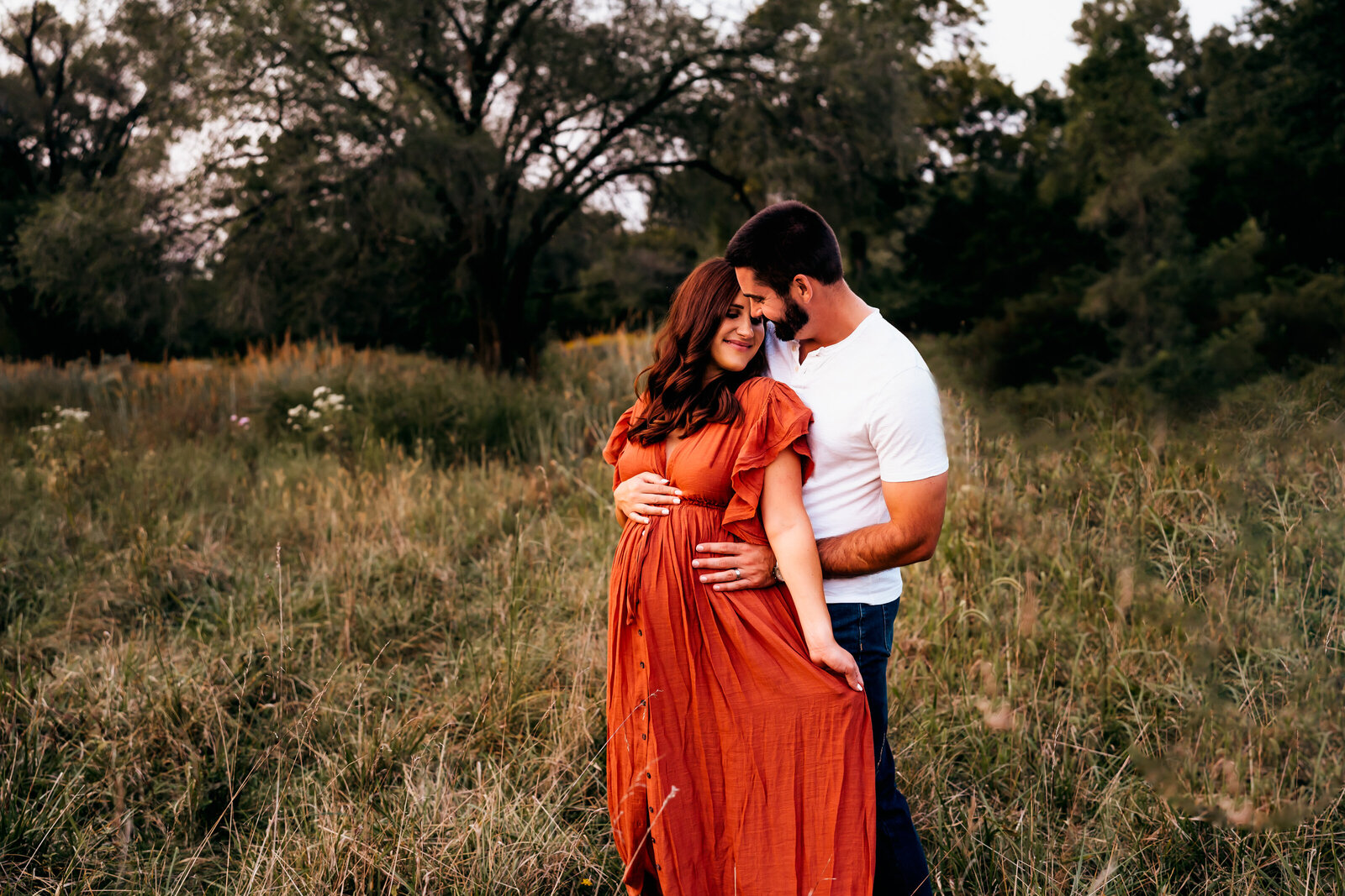 couple snuggled close during a maternity photoshoot in St. Louis