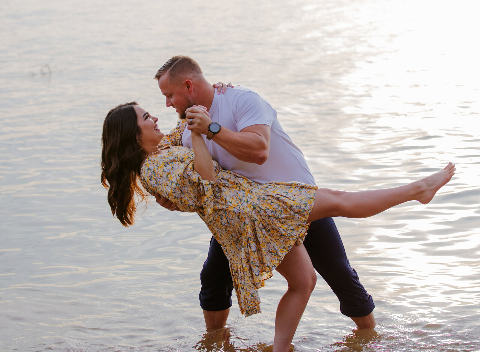 guy dipping girl in water