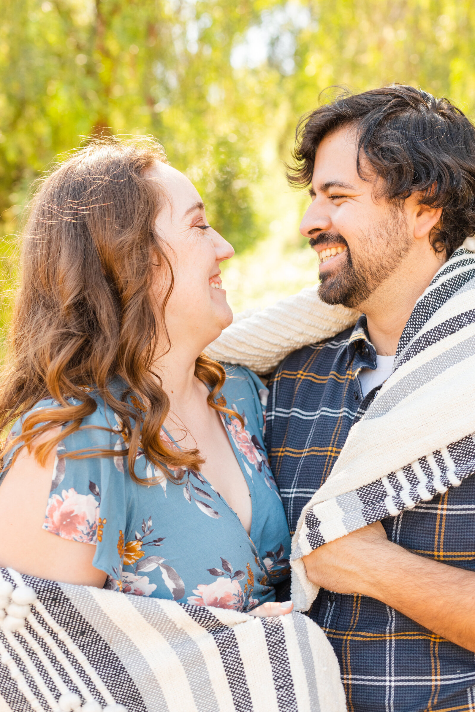 An engaged couple poses for photos in a garden in Los Angeles, Ca.
