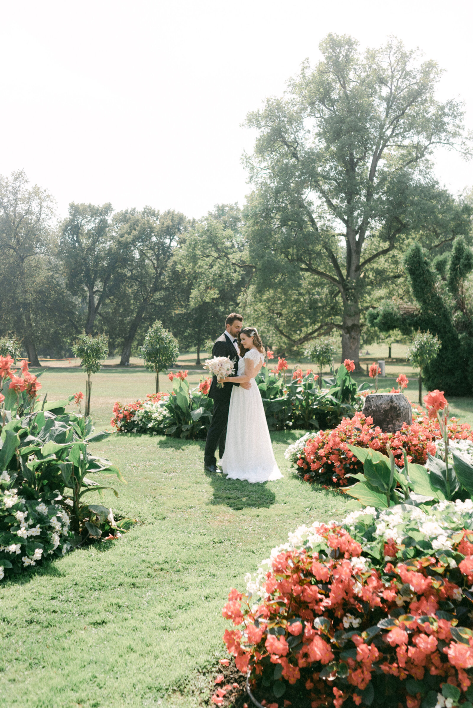 A wedding couple in the middle of flower plantations in the summer. An elopement photograph captured by Finnish wedding phootgraoher  Hannika Gabrielsson.