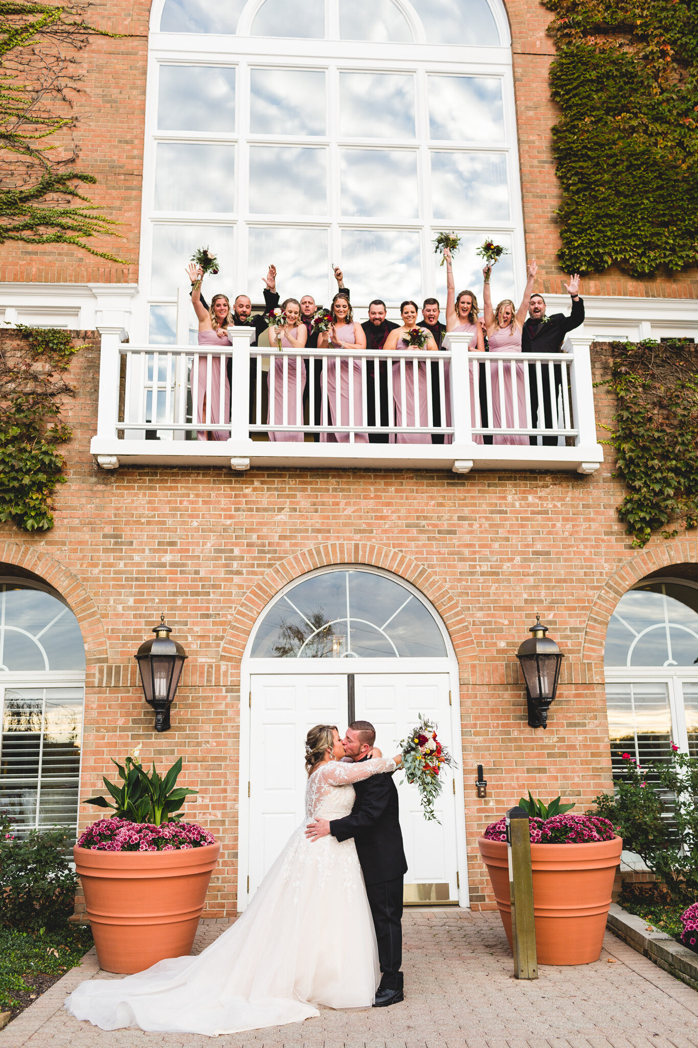 bridal party cheering as couple kisses ohio wedding photographer