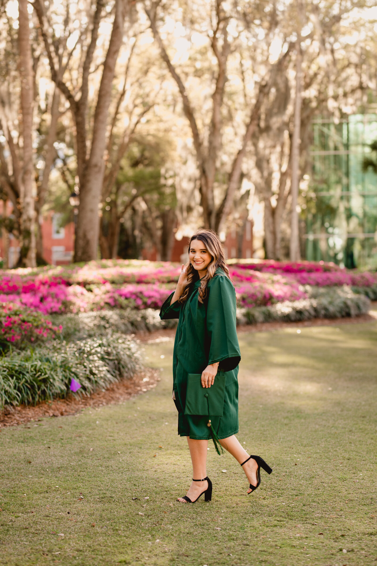 Stetson university graduate pictures on lawn with flowers.