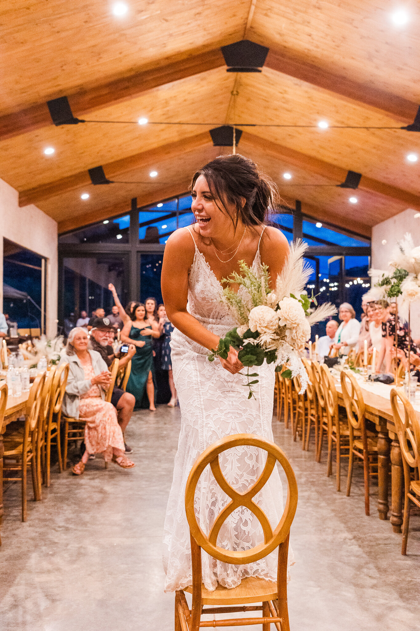 Bride throws her bouquet during her wedding reception