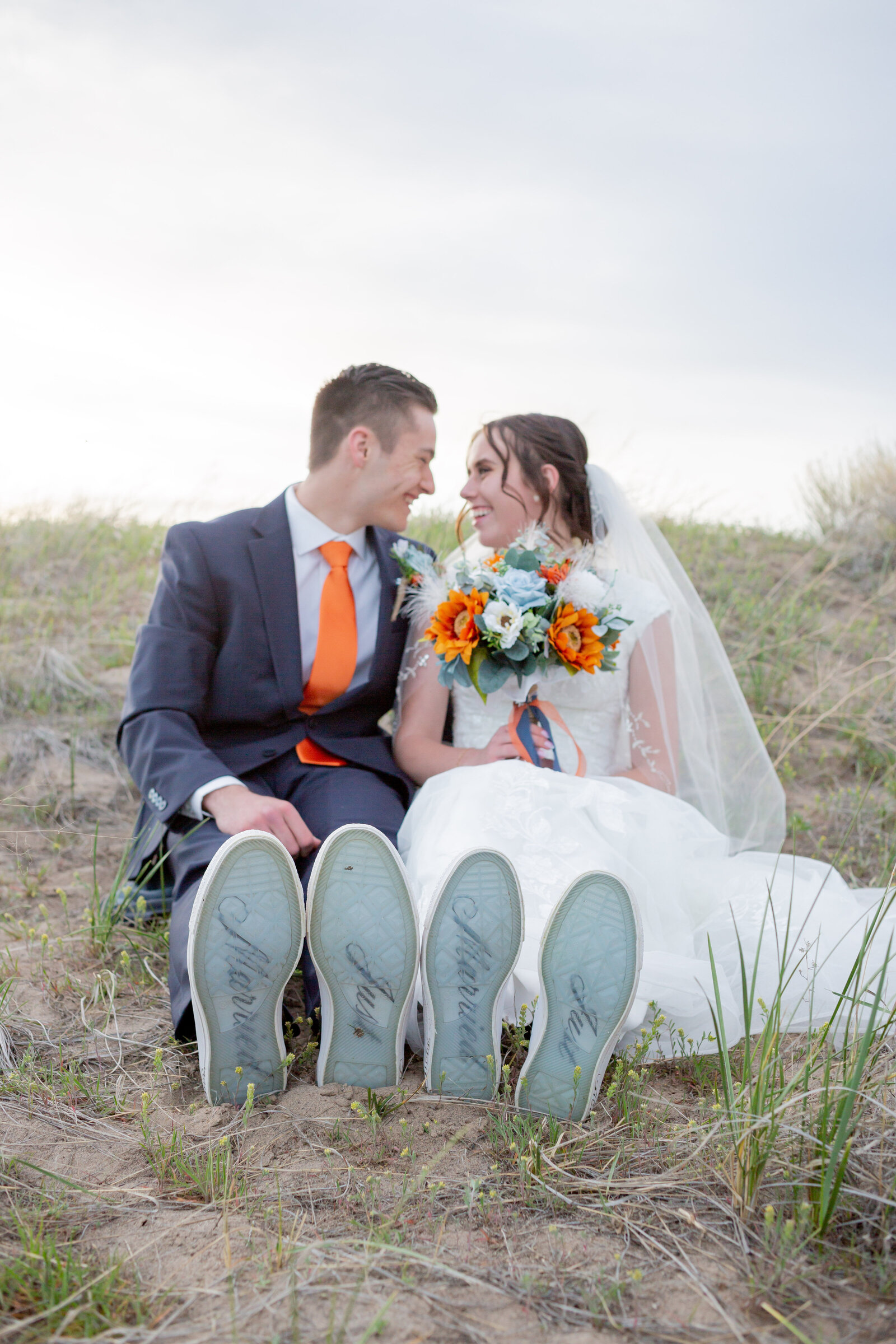 Idaho wedding photographer captures couple sitting together with matching shoes