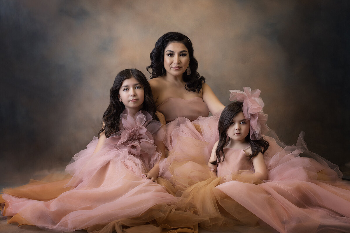 Girls pose with mother during family photoshoot.