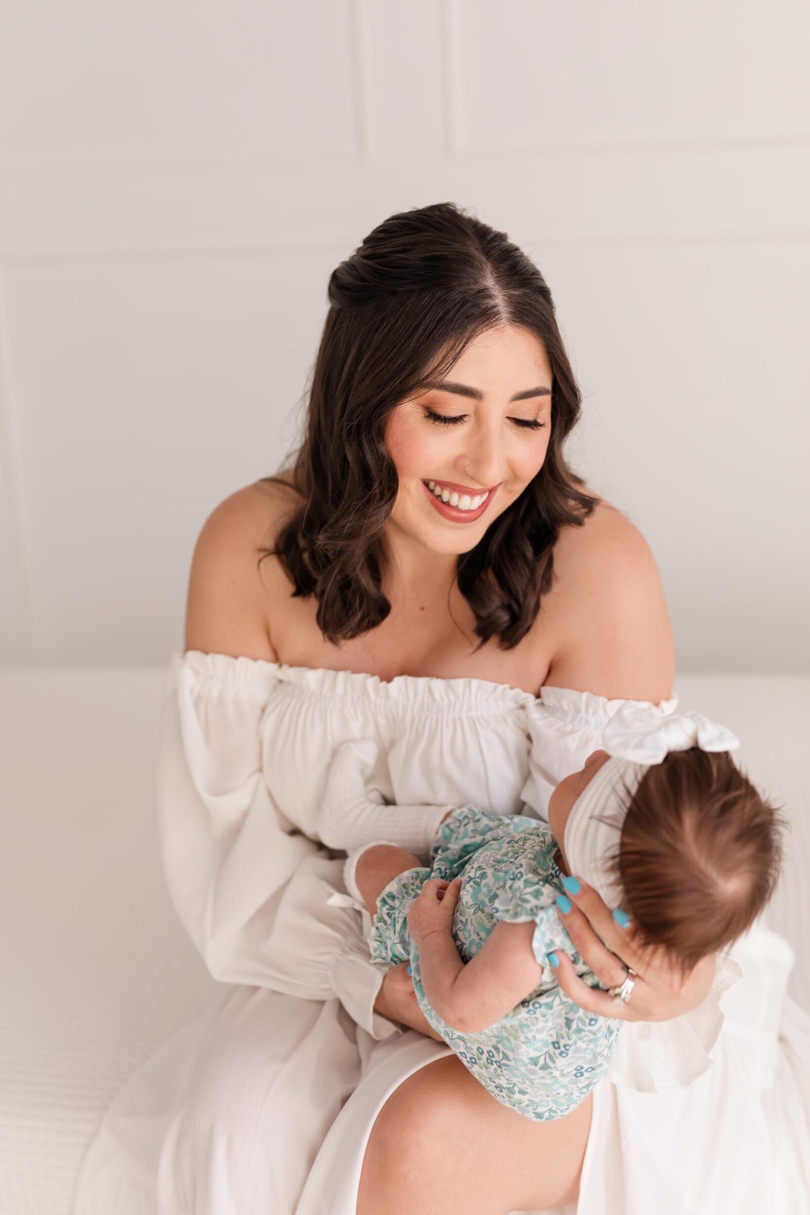 best orlando newborn photographer with photo of mom holding baby