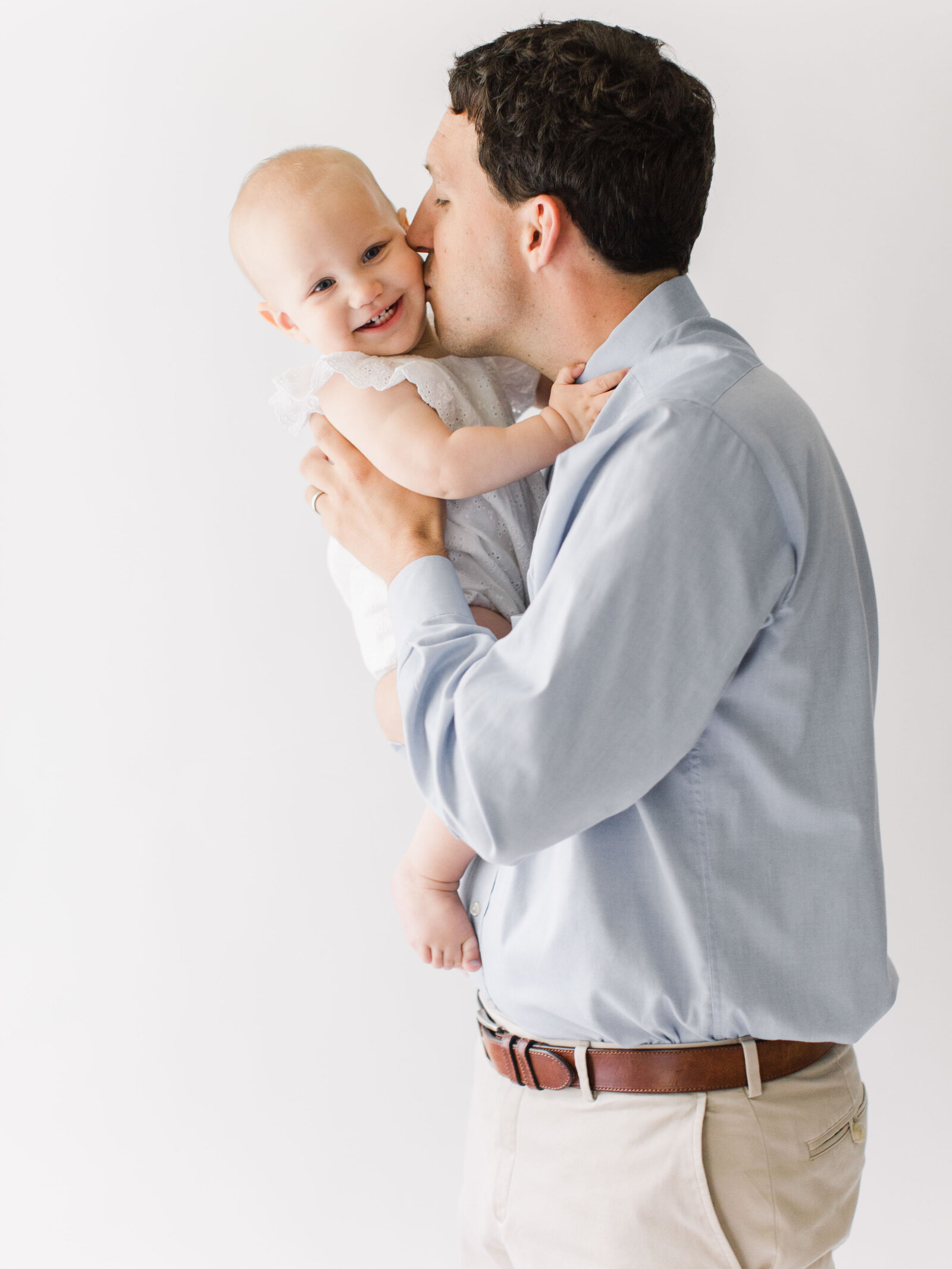 Candid photo of dad and one year old girl.