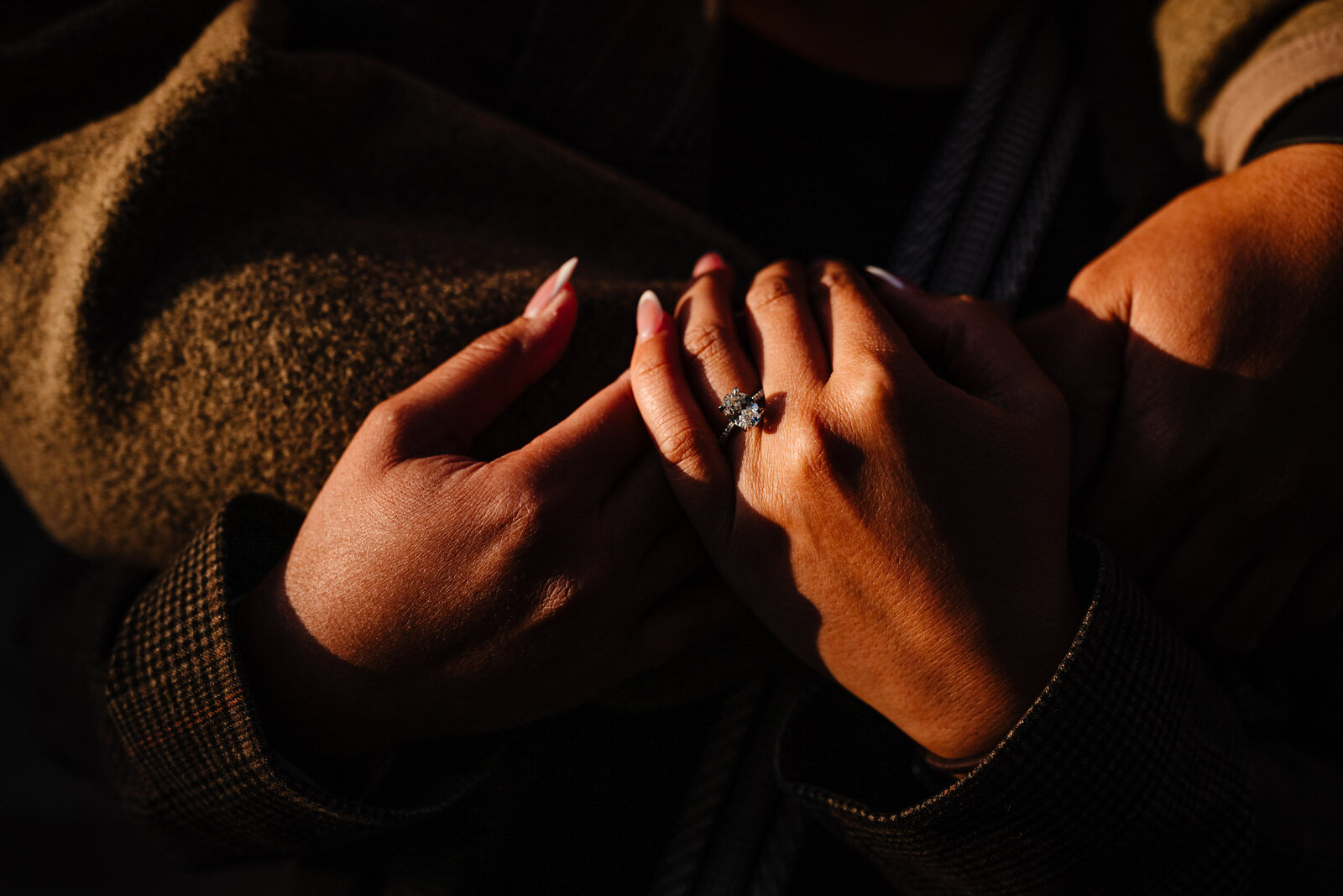 Close up of her hands with the engagement ring on, in the beautiful golden hour sunlight.