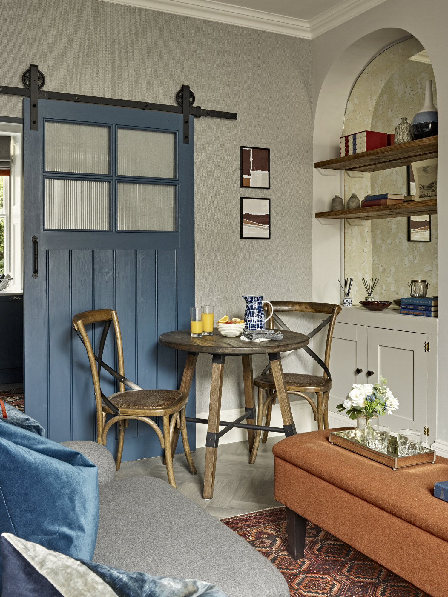 Dining area with wooden table and navy barn door