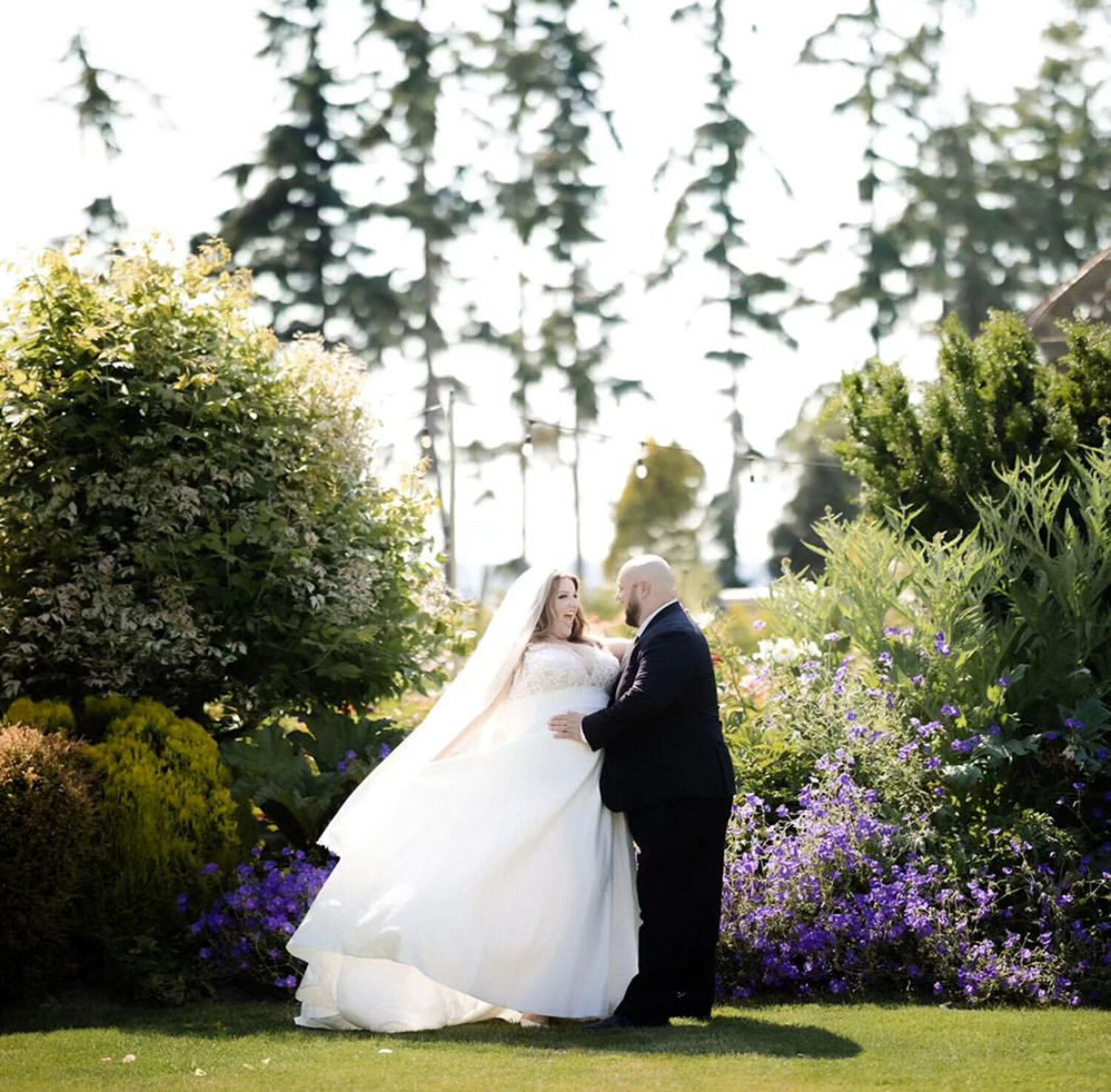 A couple sharing a romantic moment in a blooming garden