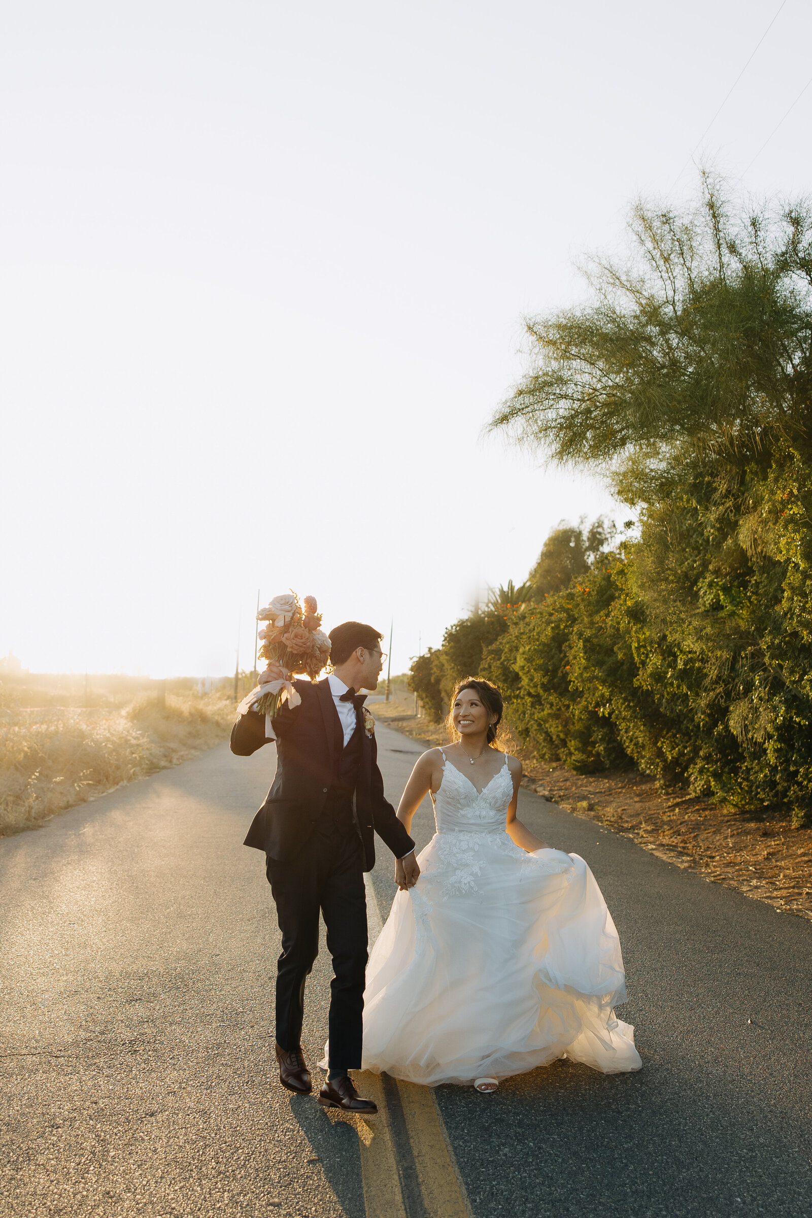 botanica wedding, bride and groom running, groom holding bouquet