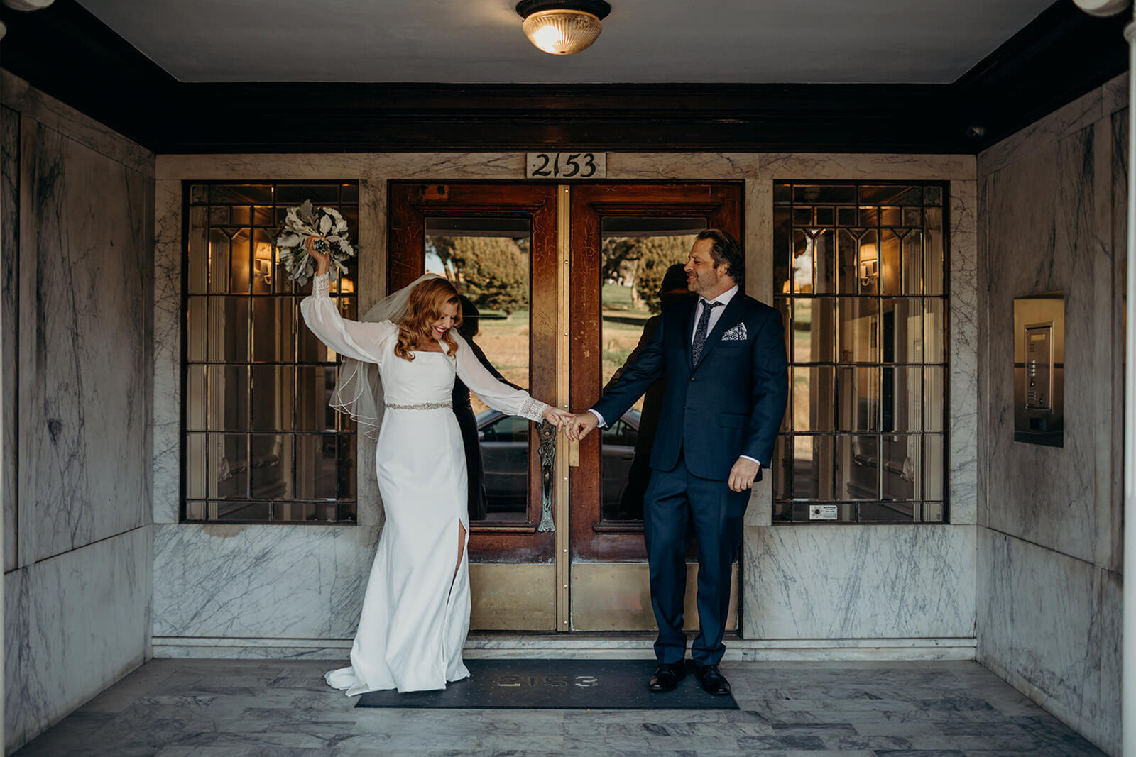 wedding couple standing outside doorway