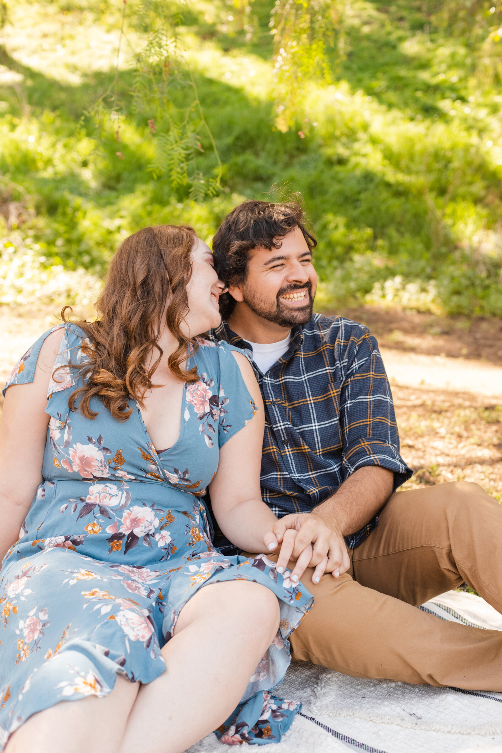 An engaged couple poses for photos in a garden in Los Angeles, Ca.