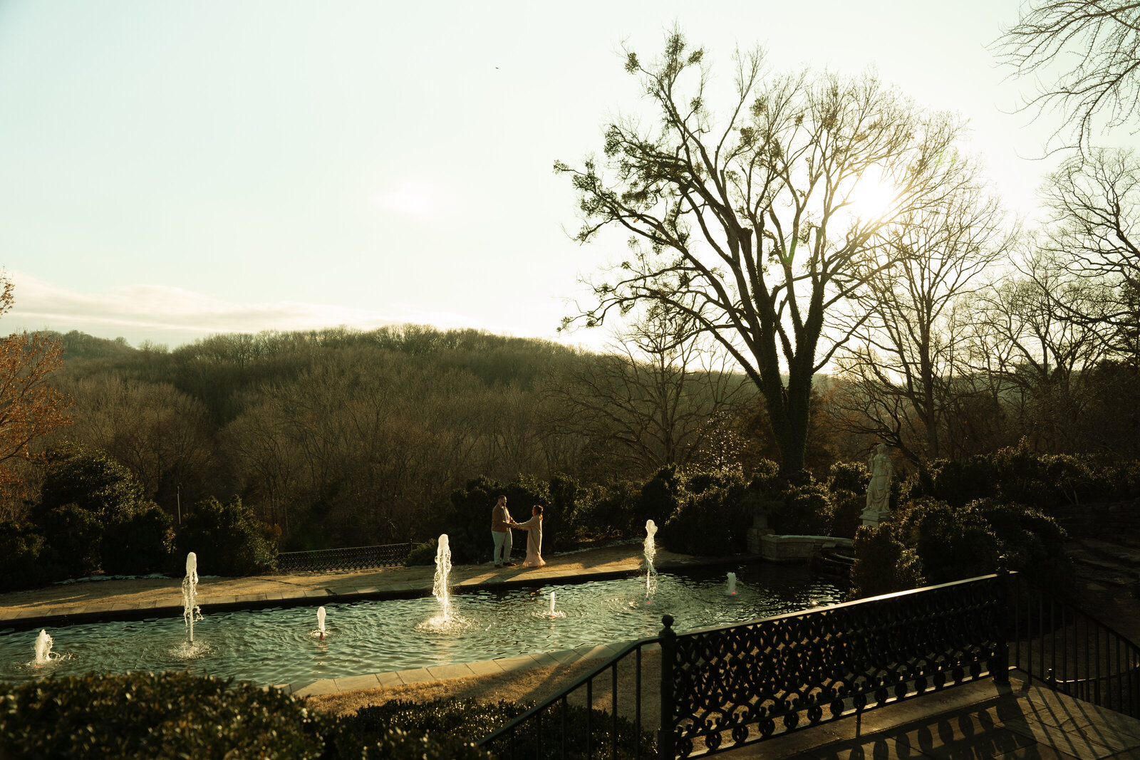An engaged couple dancing at golden hour in Cheekwood Garden Nashville, captured in a documentary way.