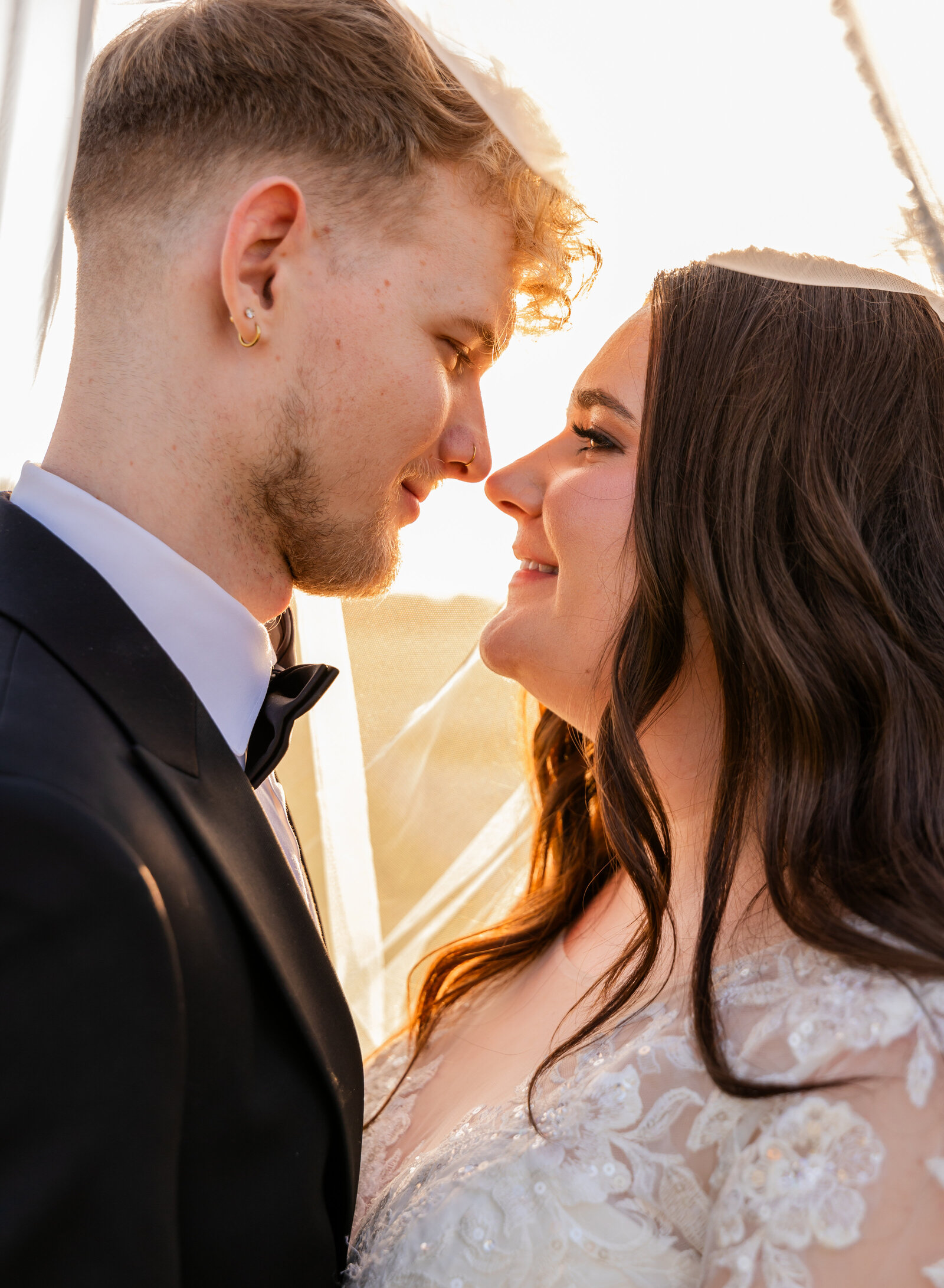 couple smiling under veil