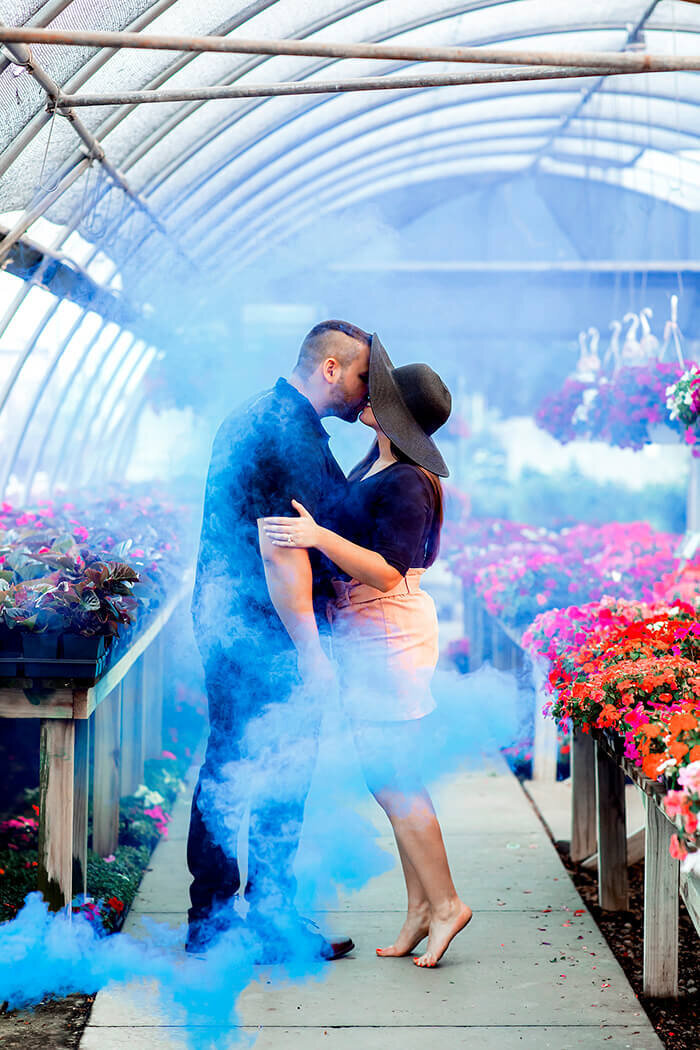 man-and-woman-kiss-blue-smoke-greenhouse