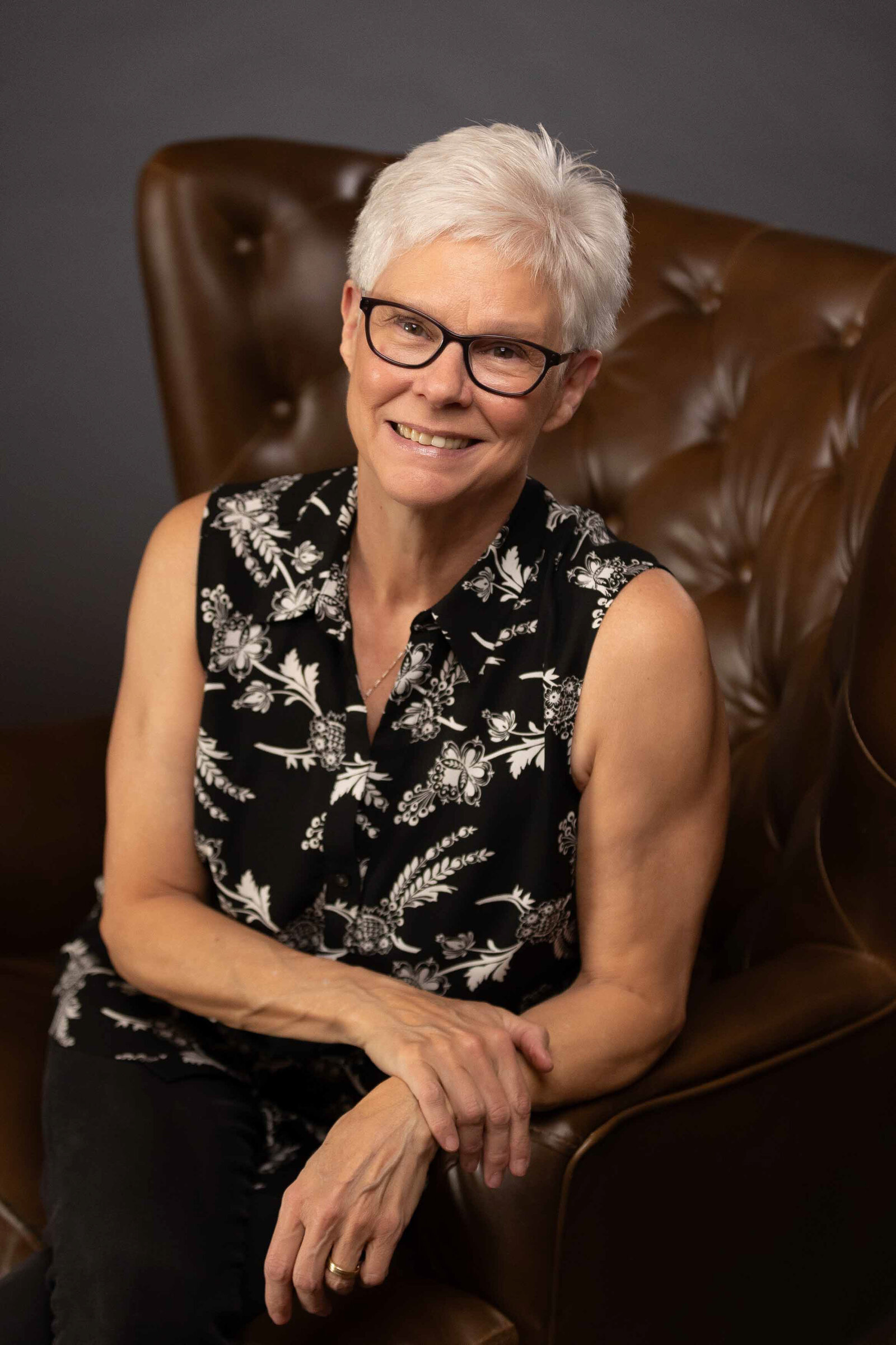 woman in formal attire sitting in a couch