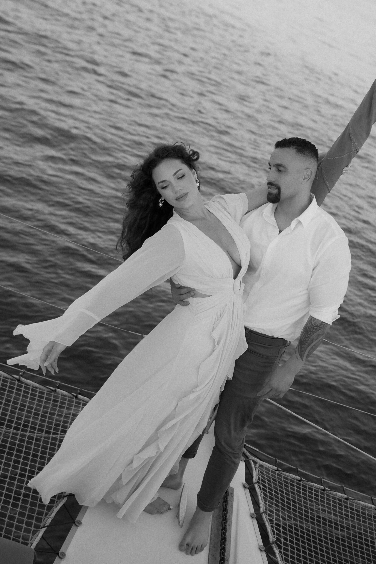 couple holding onto each other during southern california beach photoshoot