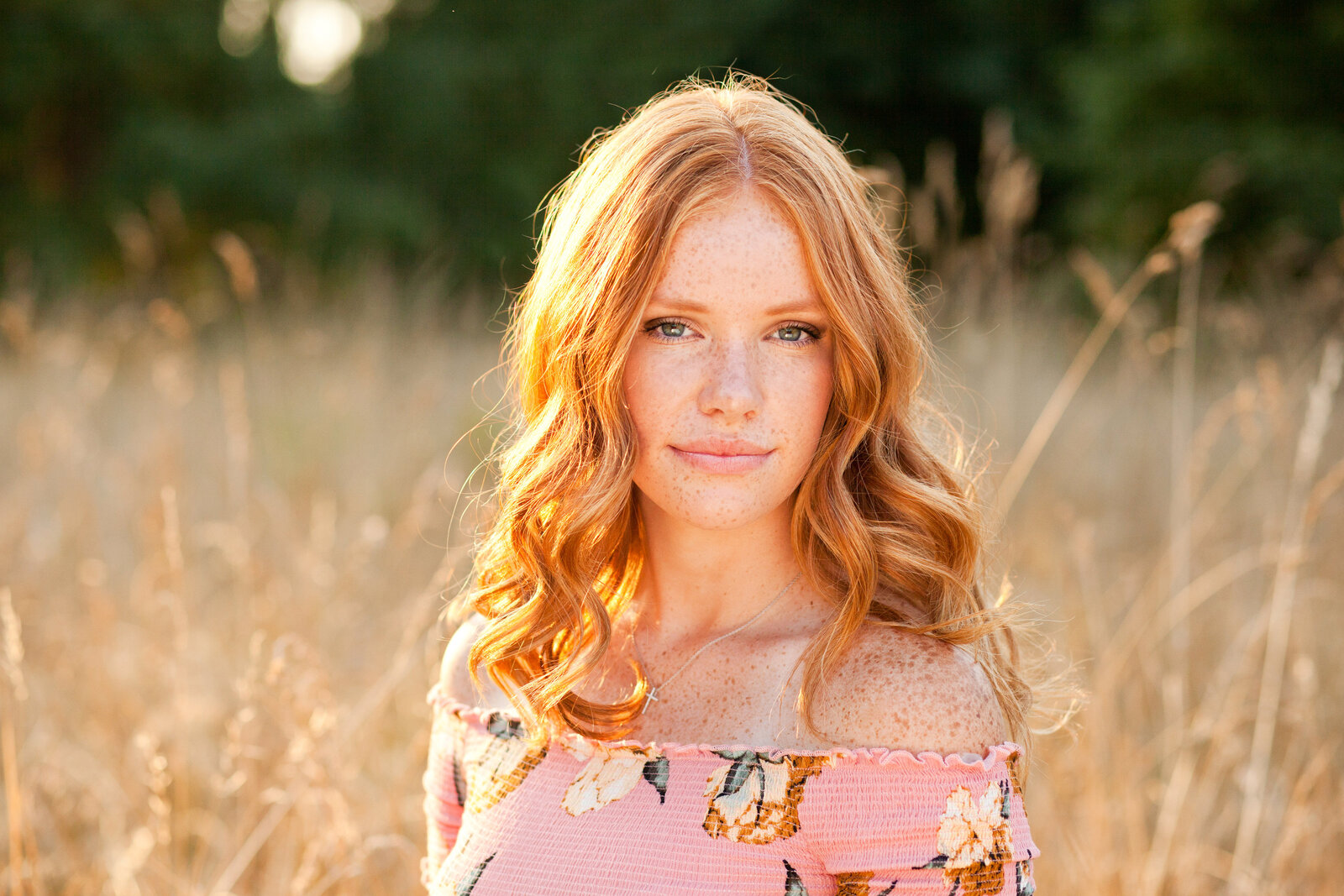 senior photos red head senior girl field golden hour smize