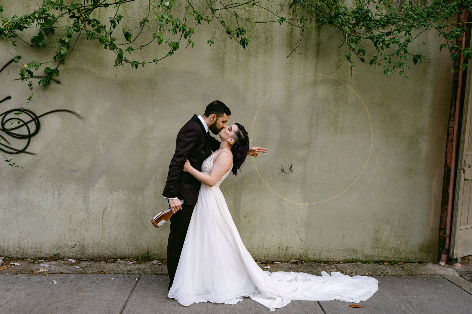 wedding couple celebrating bride and groom kissing