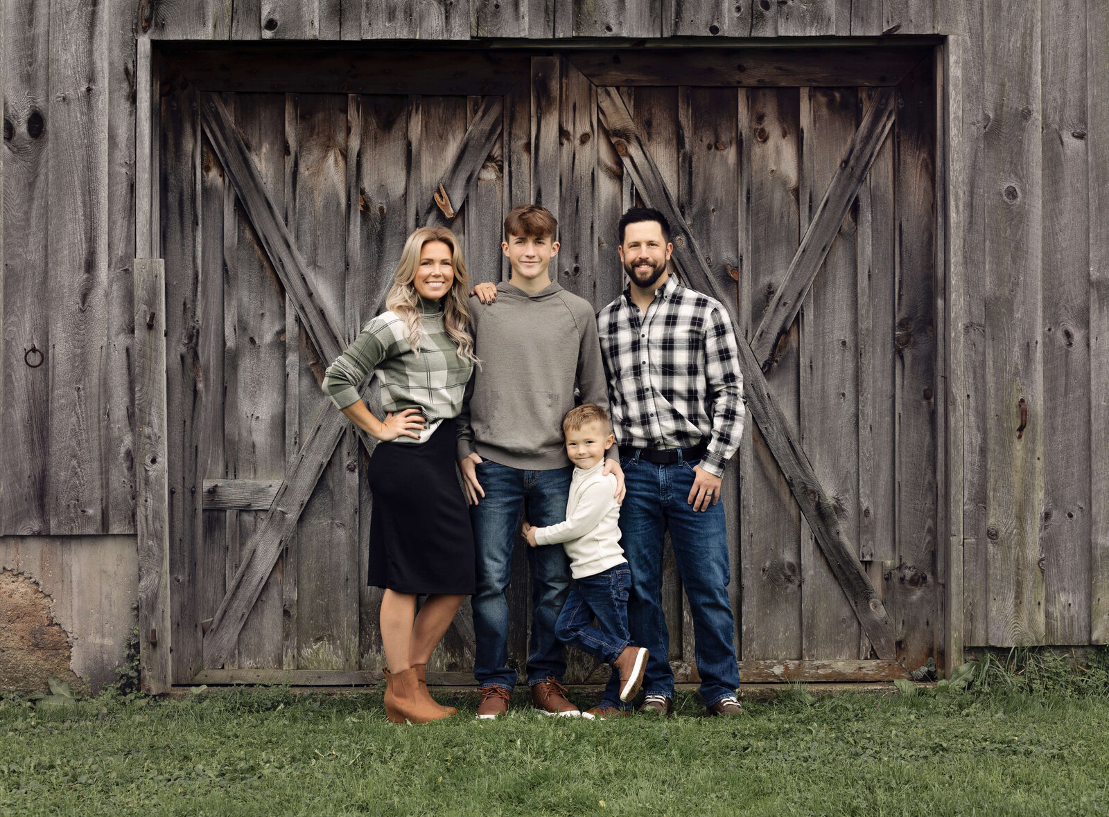 Photo of a family standing by a barn door in Erie Pa