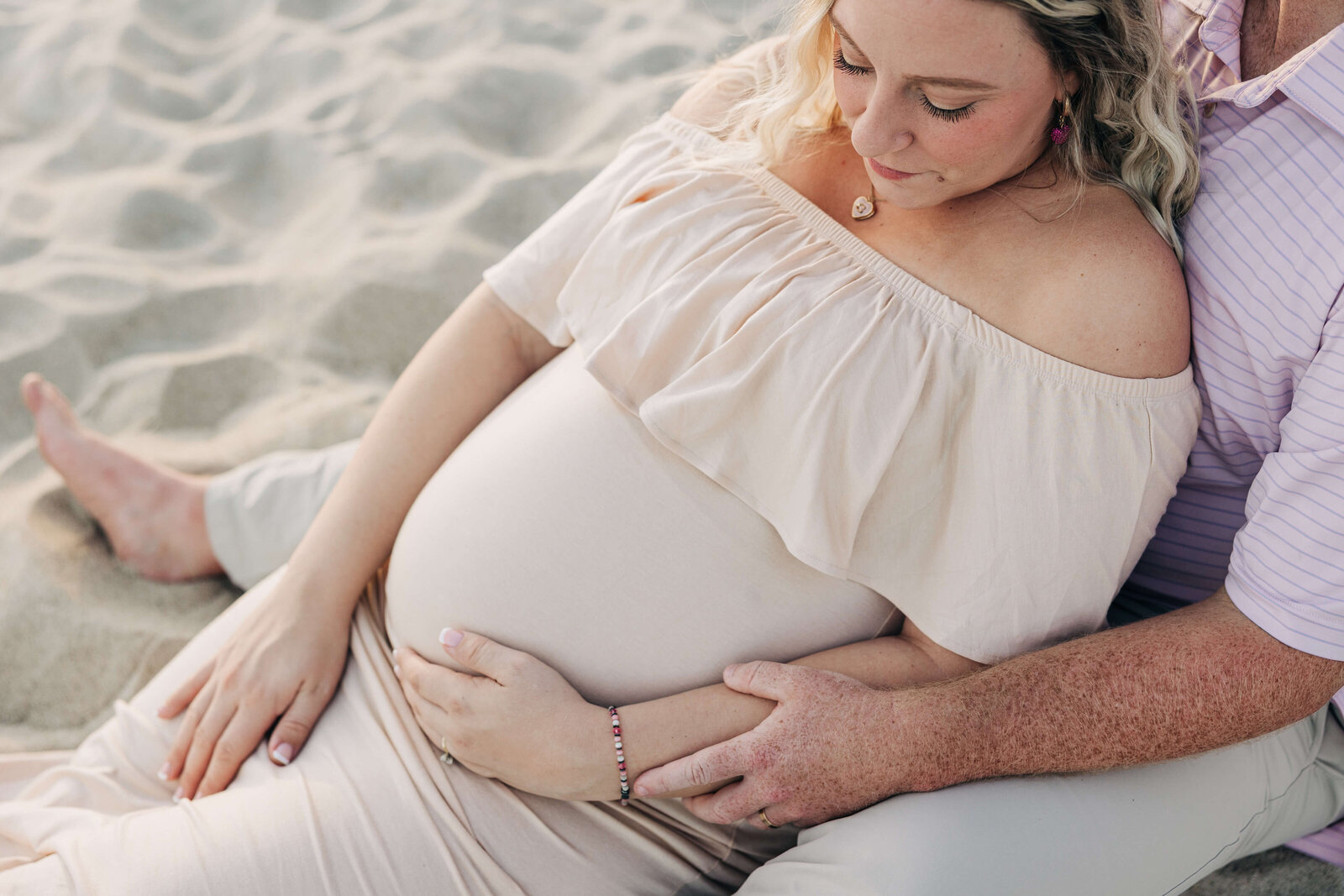 Mom-looking-at-baby-bump-Ocean-Isle
