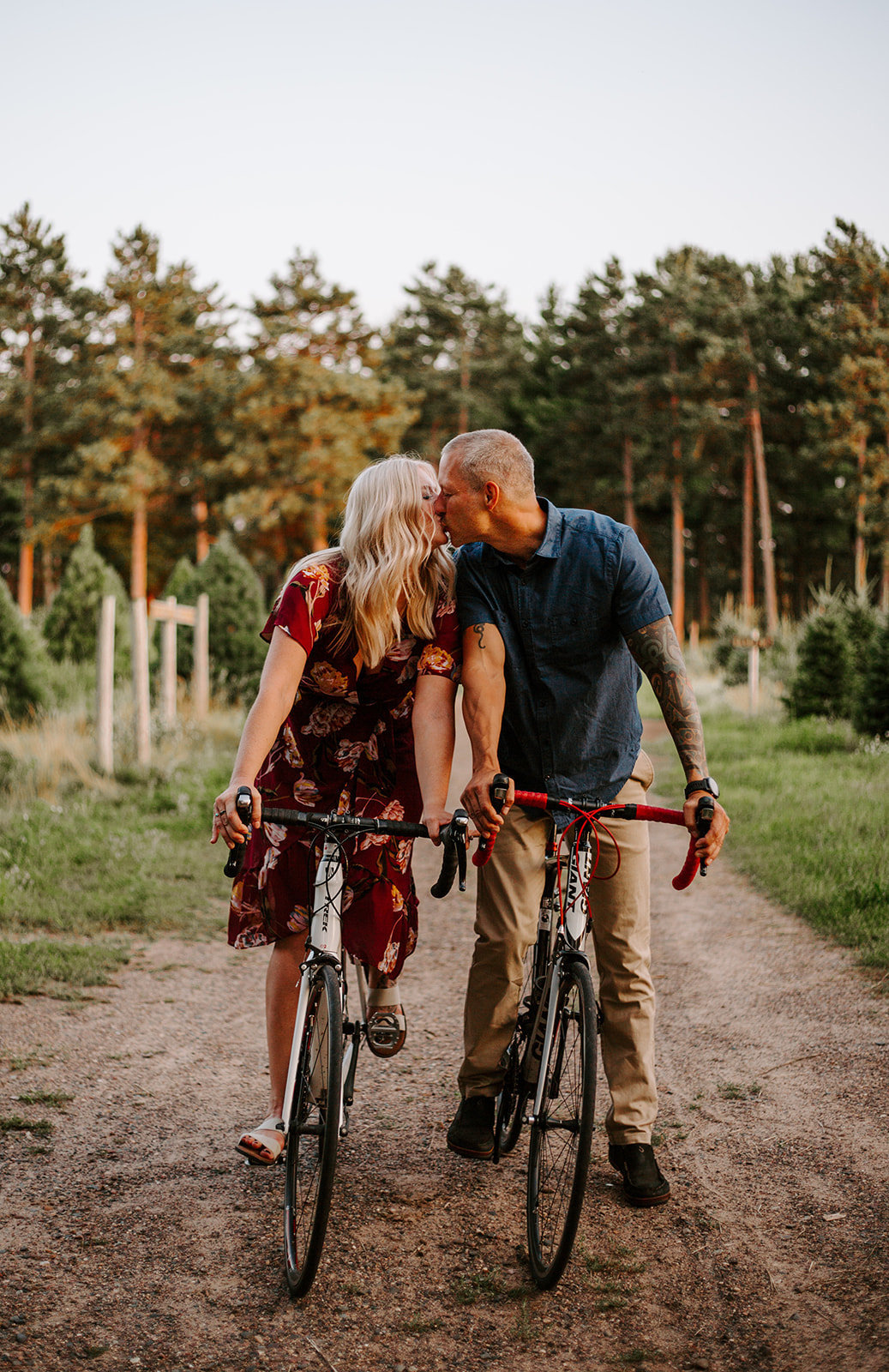 A couple riding bikes and sharing a kiss during their Minnesota engagement session