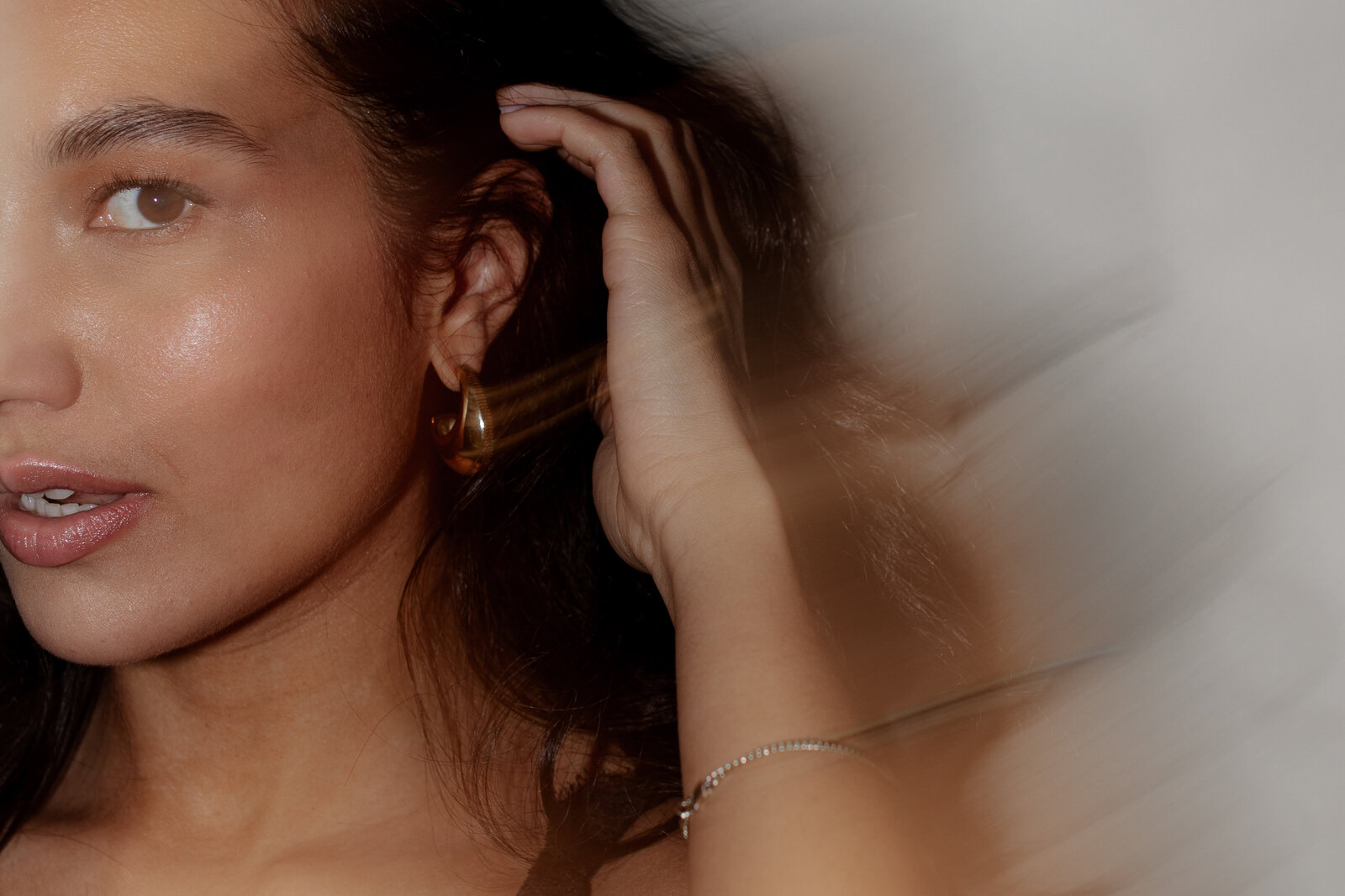 Luxury-inspired nude empowerment session with dramatic lighting and shadows.
