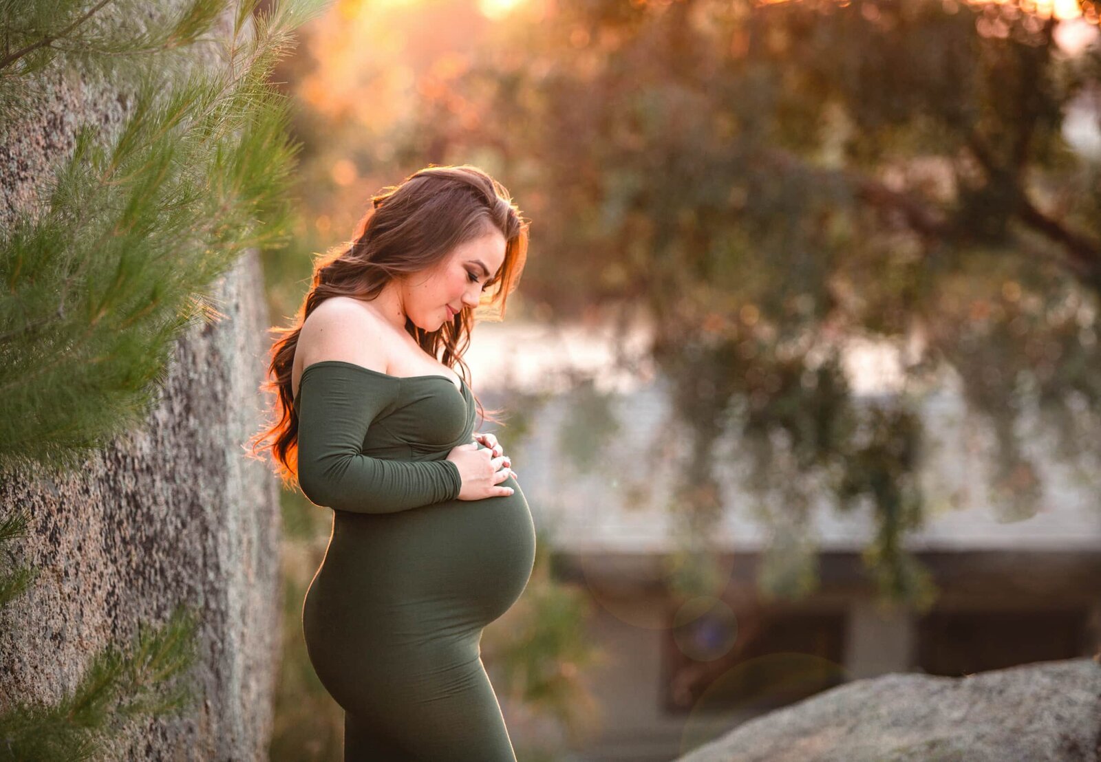 Maternity portrait outdoors in green dress