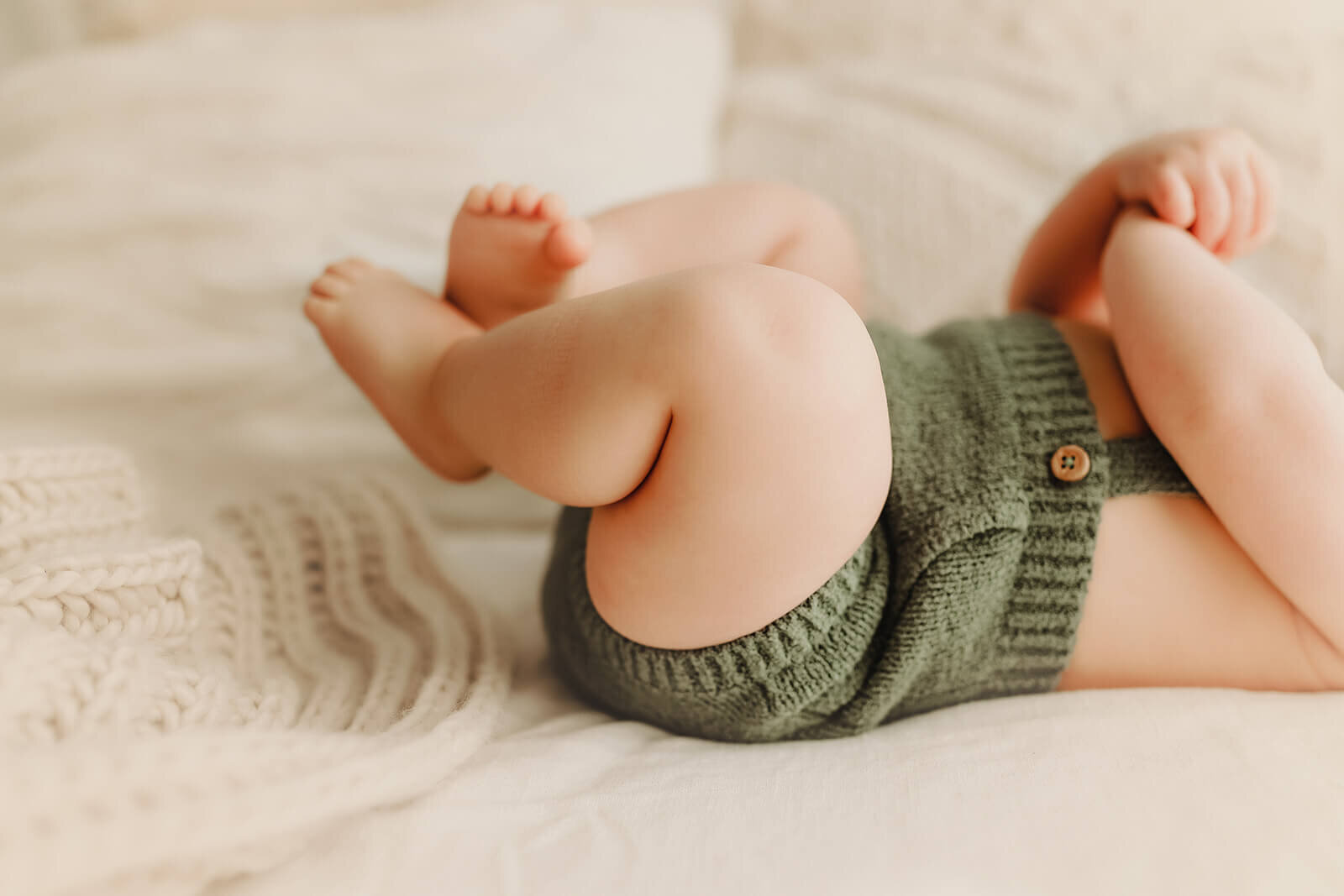 precious details of a 6 month old baby boy's chunky thighs and pudgy feet