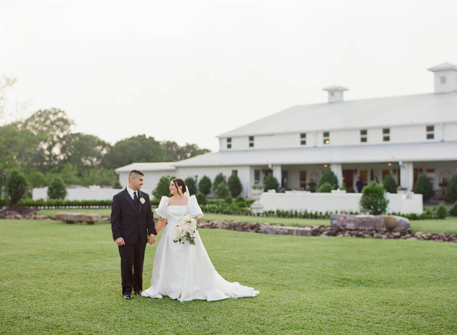 bride and groom walking outside wedding venue in New Orleans, LA