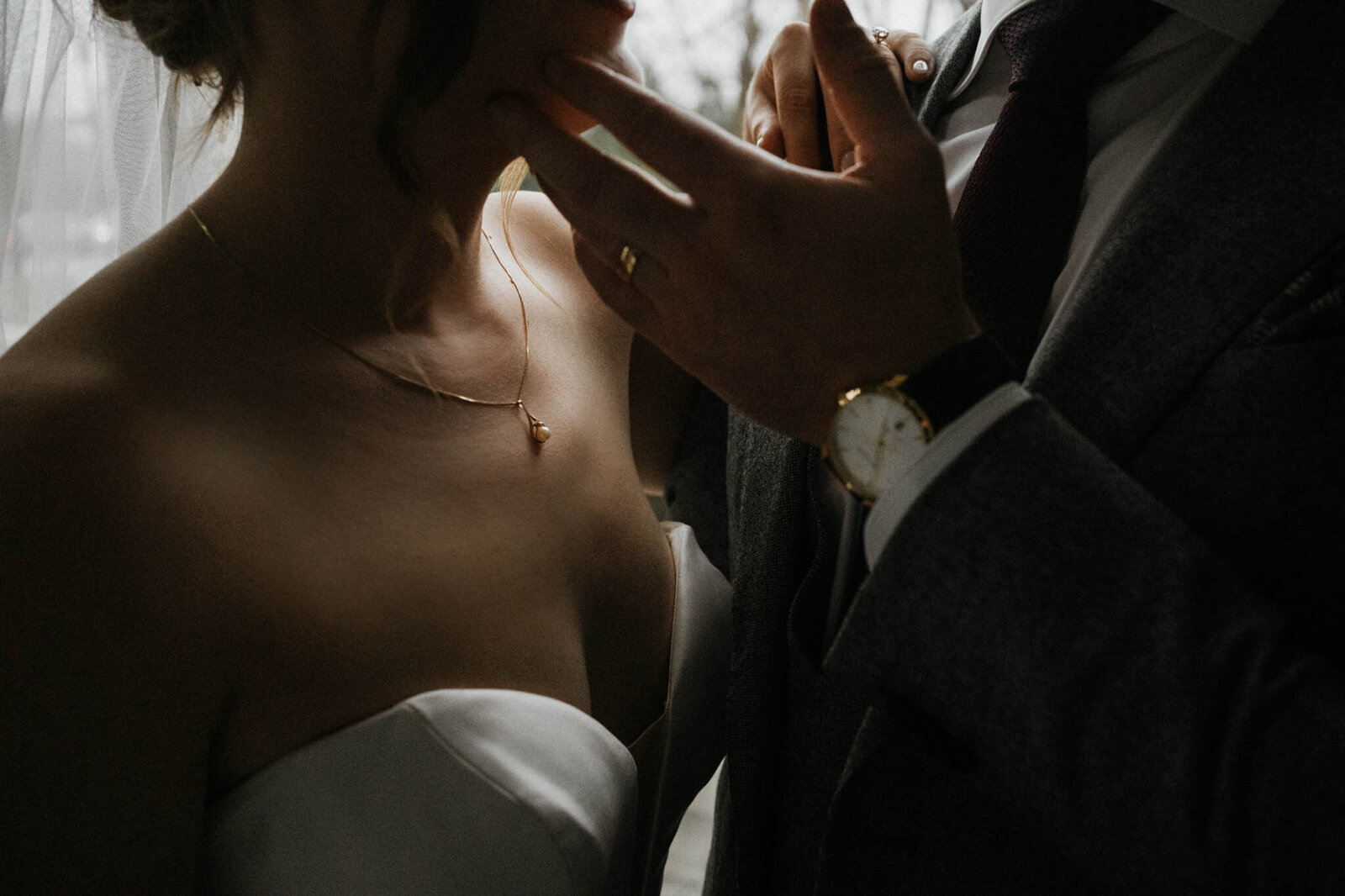 A close up detail shot of a couple on their wedding day in Nashville Tennessee where the groom is holding the brides chin about to kiss her.