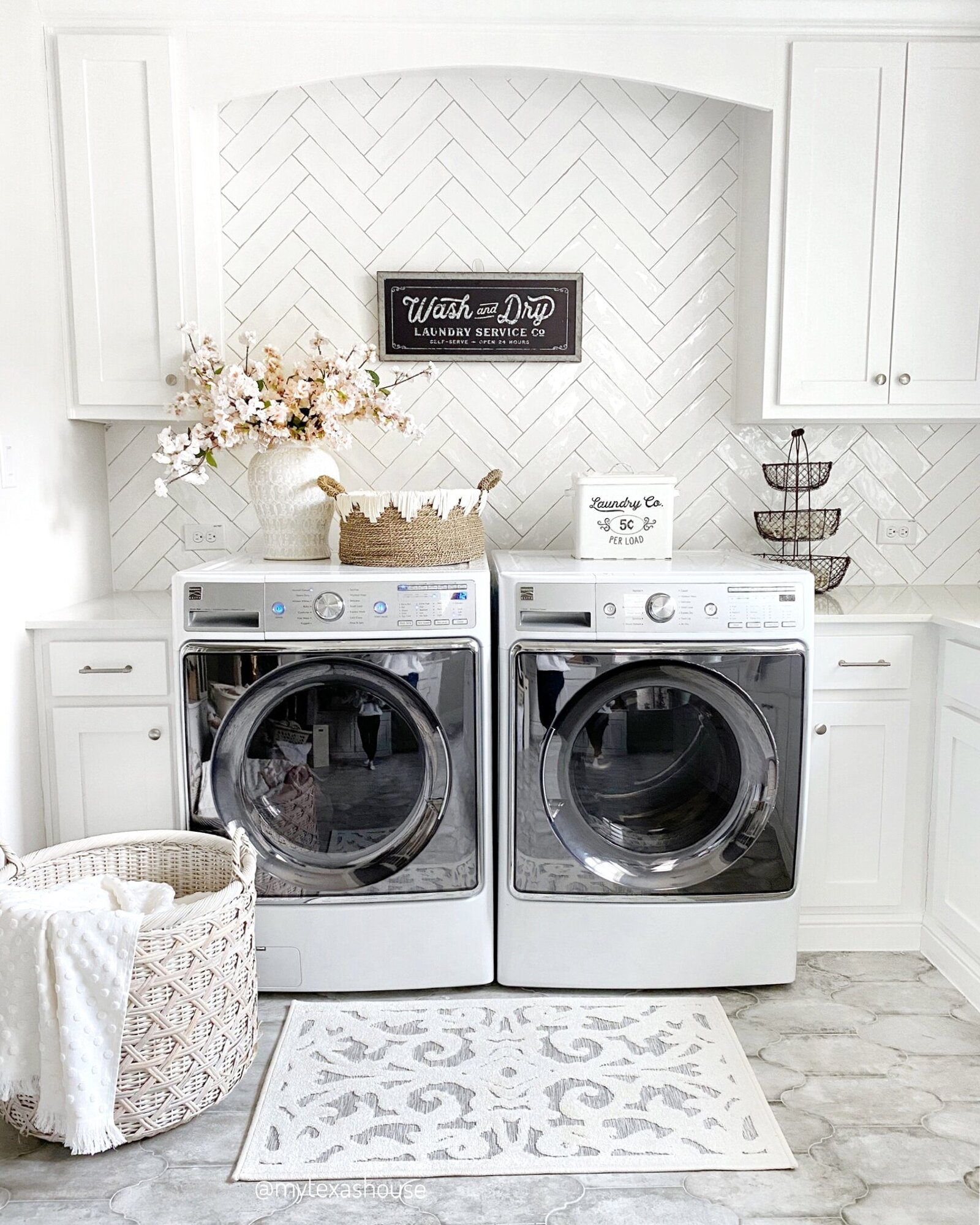 Laundry room with a hamper with a MTH throw inside
