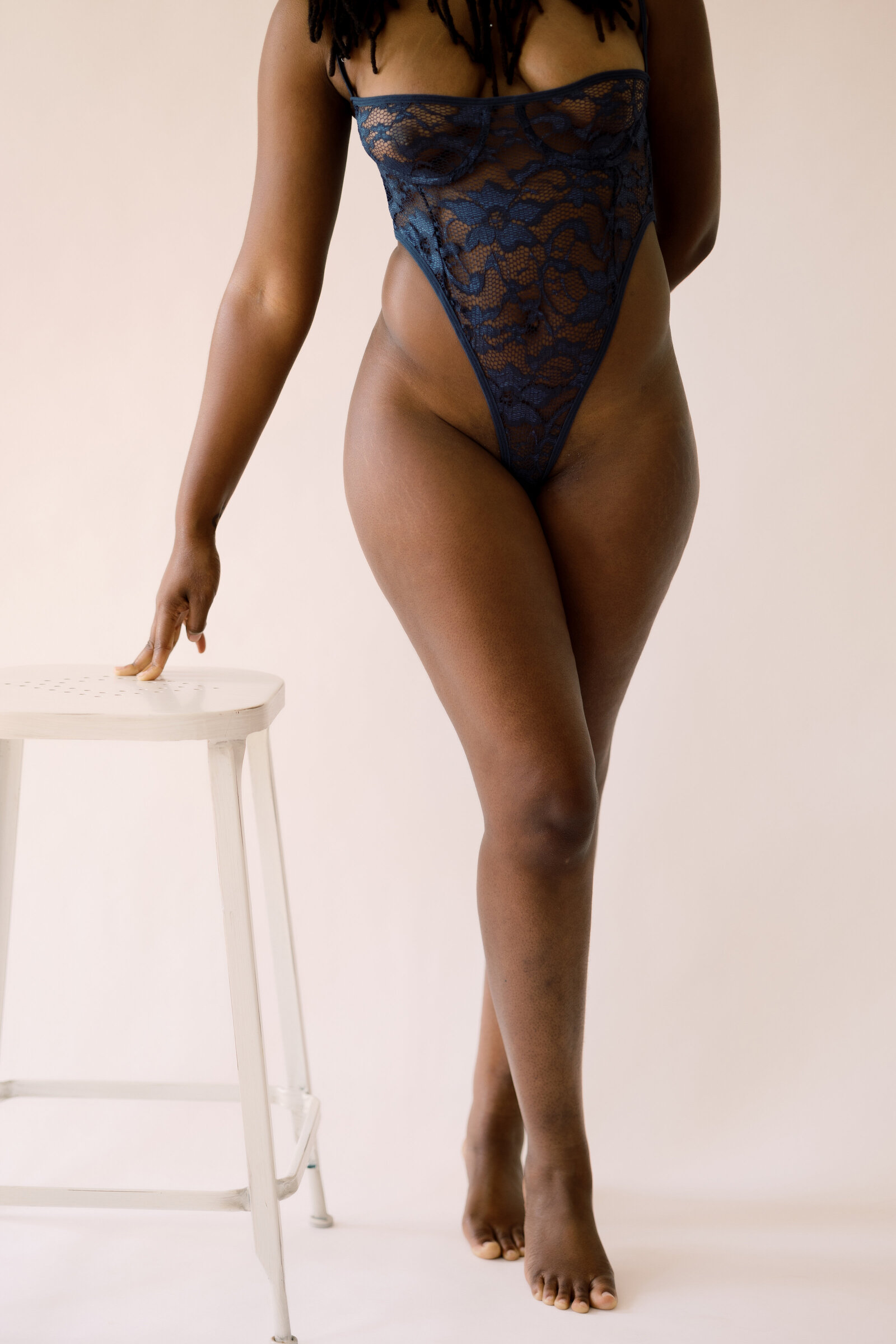 Black woman wearing lacy black lingerie
