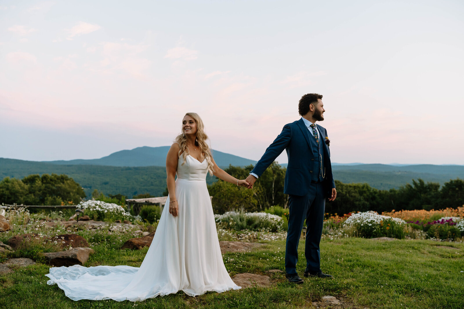 Bride and Groom holding hands on mountain top in New Hampshire wedding 