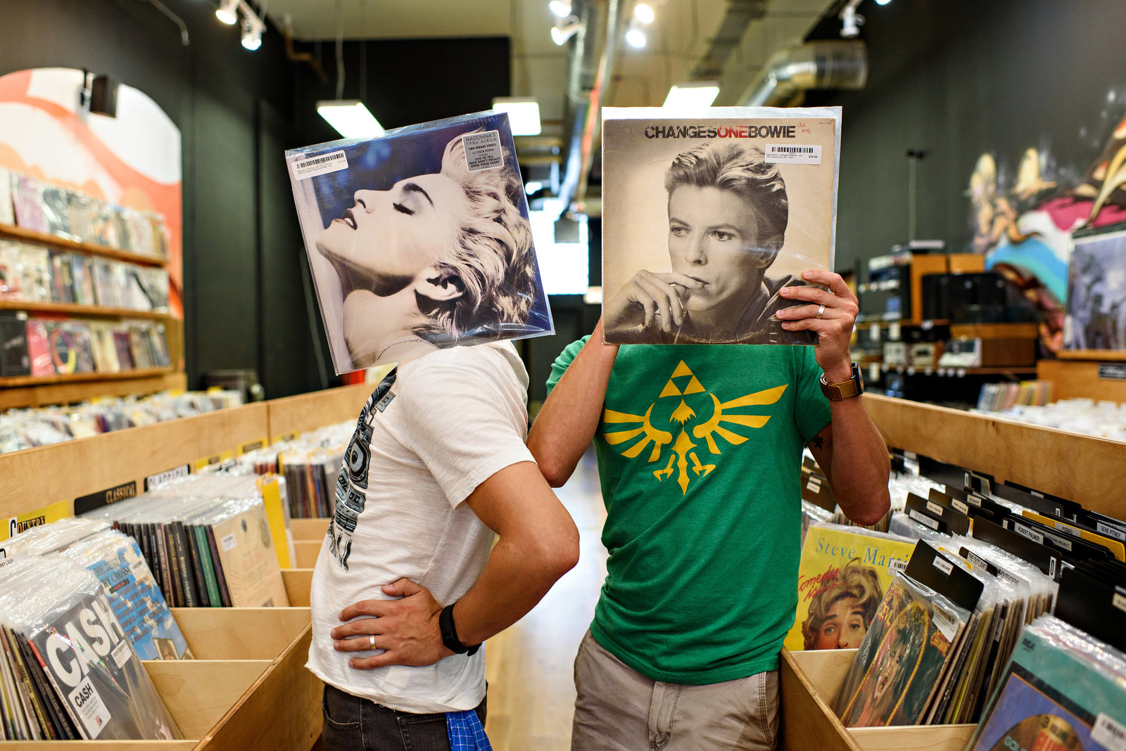 An engaged couple have fun in a chicago record store.