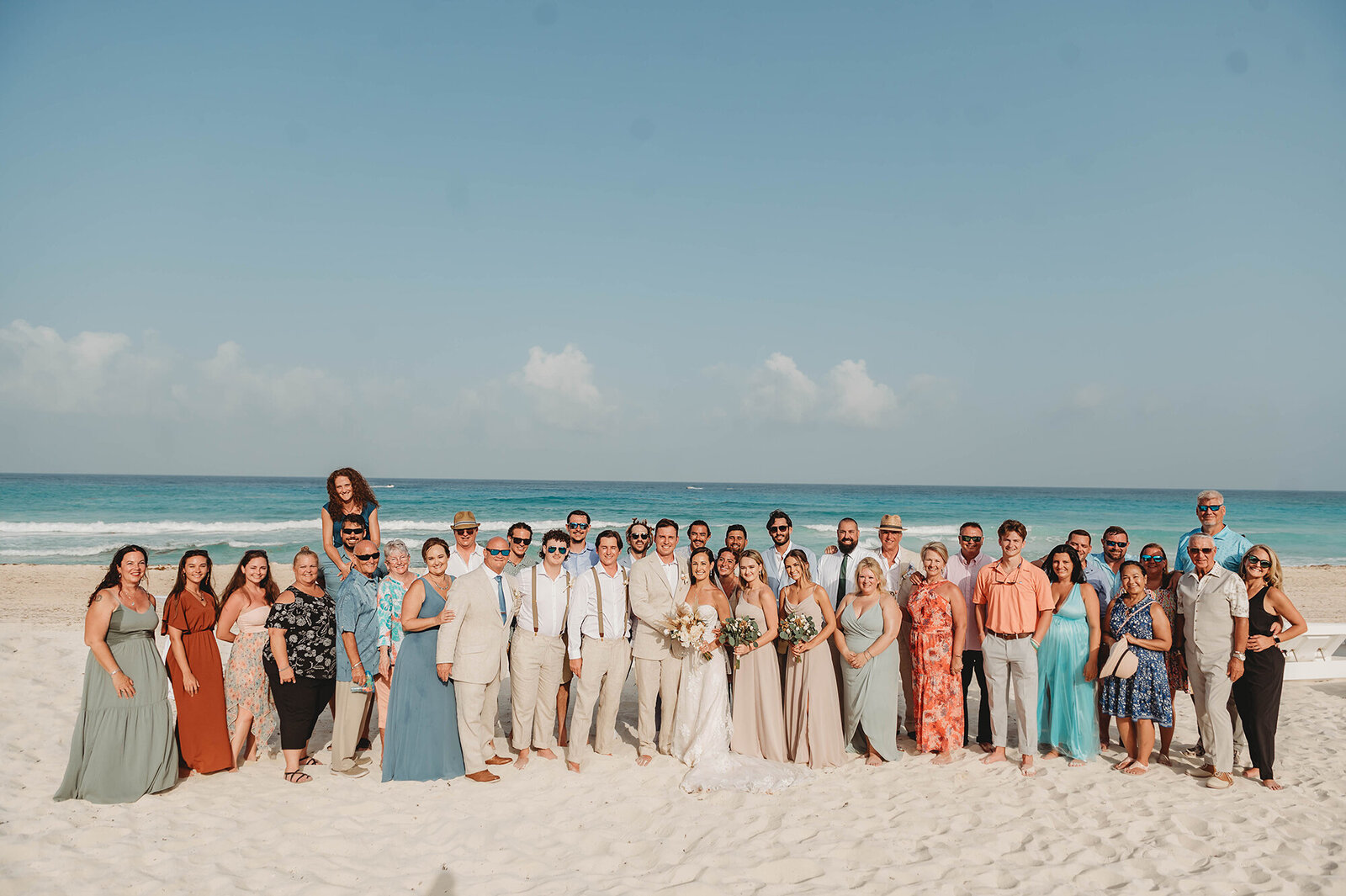 Newlyweds pose for portraits with their family and friends after their Micro Wedding Ceremony at Live Aqua Resort in Cancun Mexico.