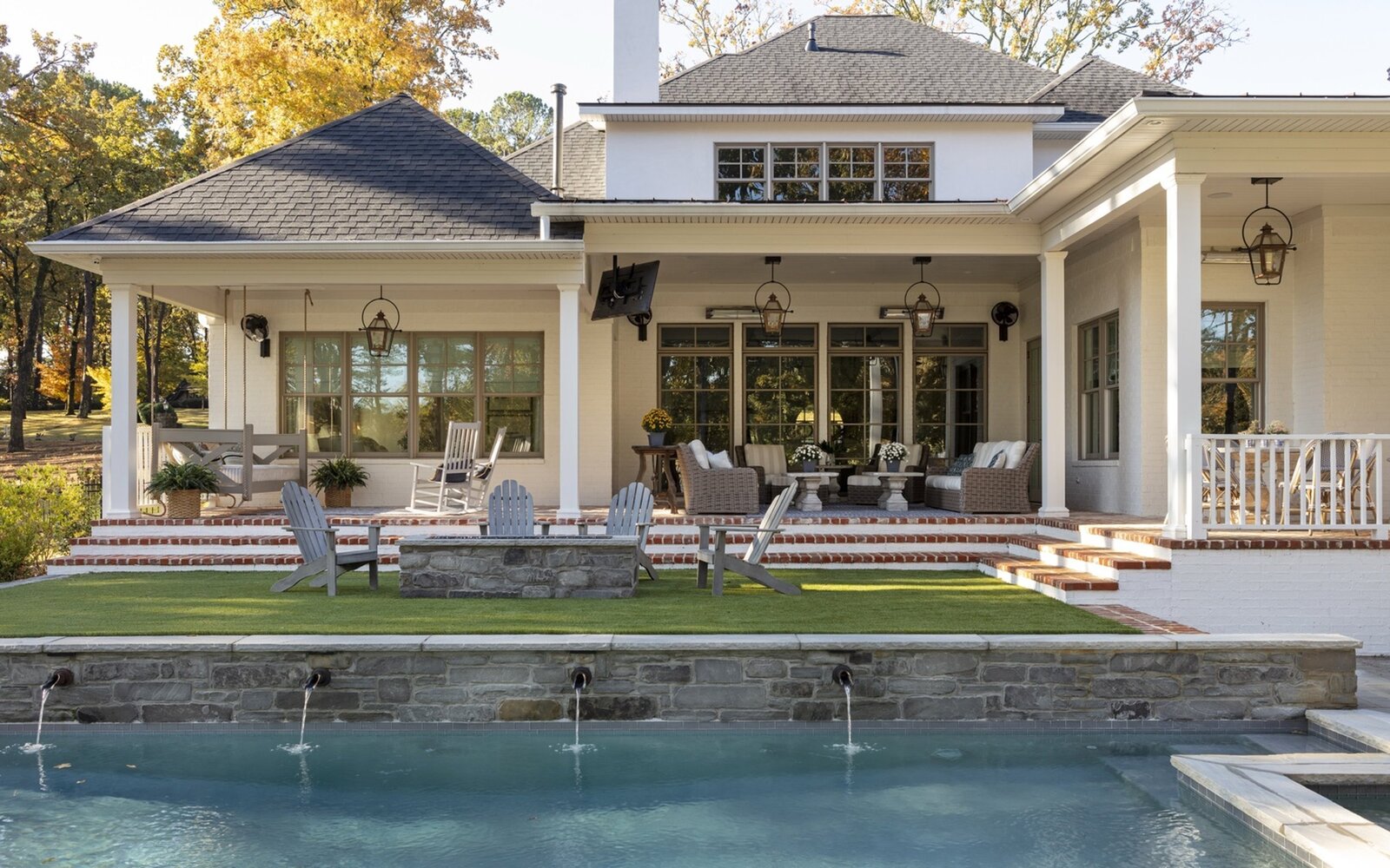elegant-backyard-porch-pool-rocking-chairs-water-feature