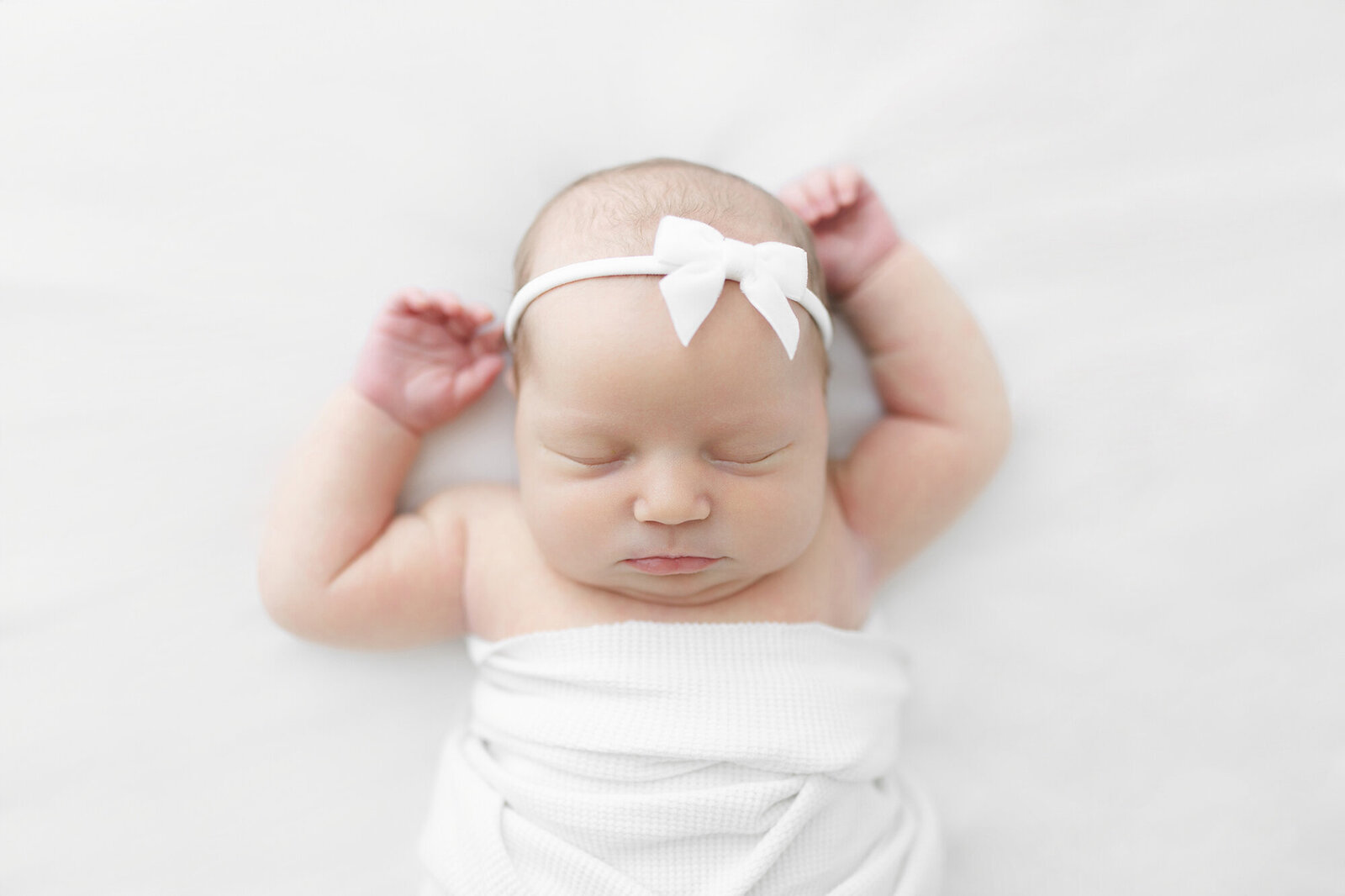 Newborn baby peacefully sleeping on white blanket | Grand Forks newborn photographer Chelsea Nichole Photography | North Dakota newborn portraits