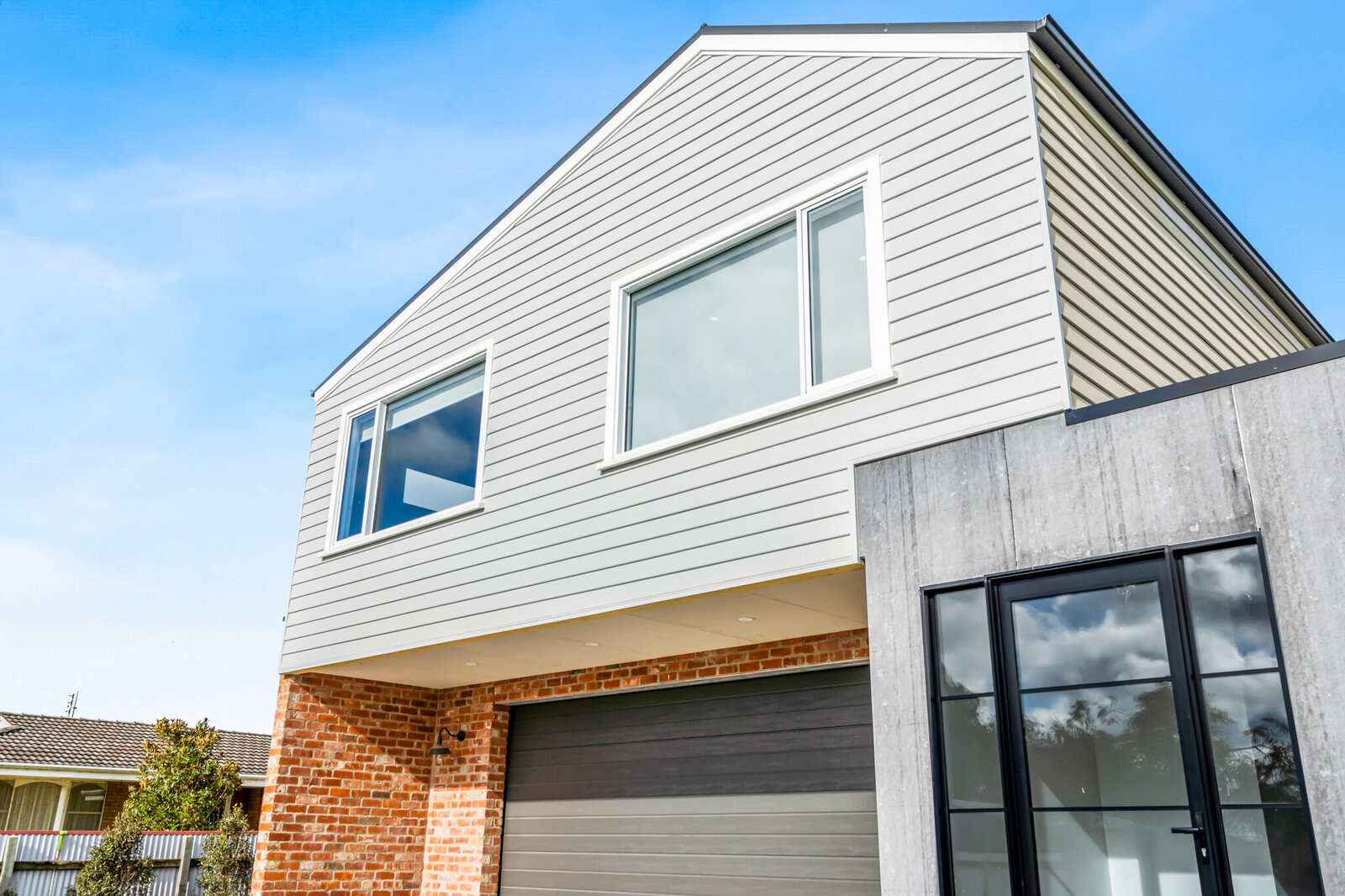 Red brick and colourbond house modern home design by WBK Building