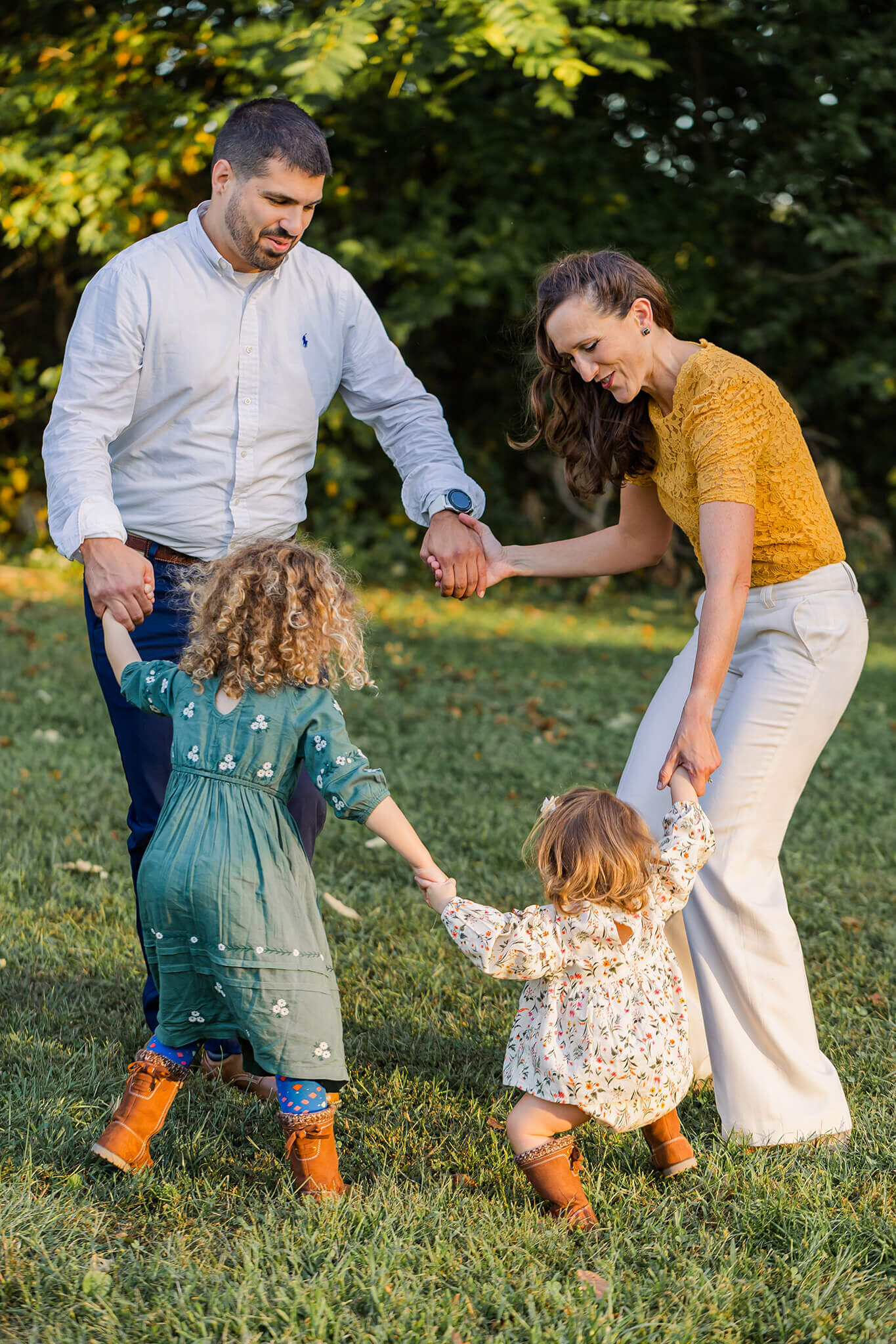 A family of four playing ring around the rosie during a session with Northern Virginia family photographer, Melissa Driggers.